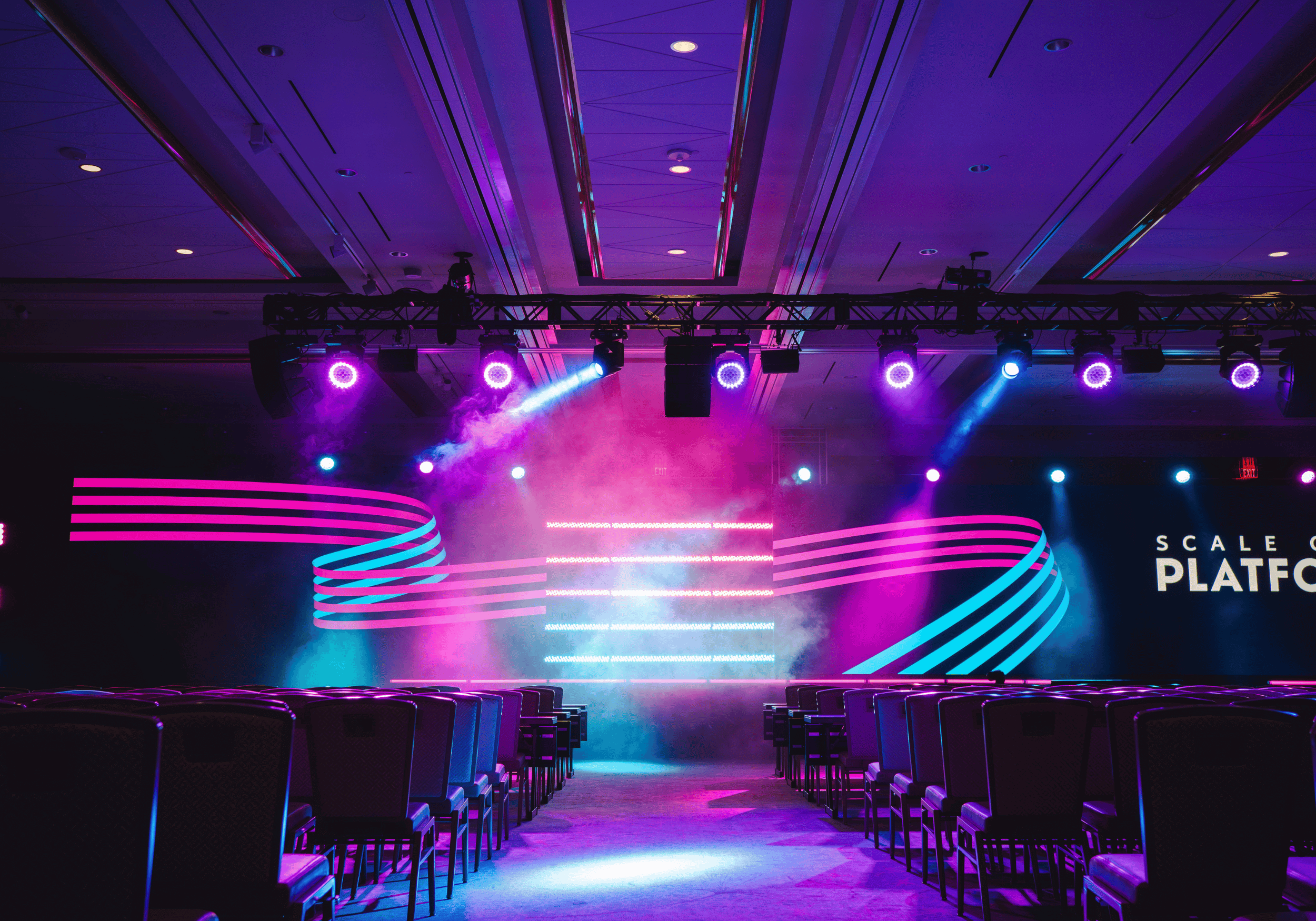 Center shot of Scale Computing Platform's main stage with lighting hanging from truss rigged to the ceiling.