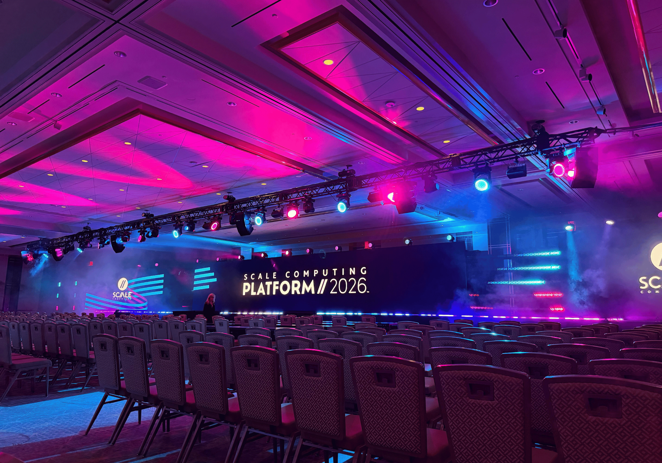Aesthetic photo of Scale Computing Platform 2026 main stage with pink and blue lighting.