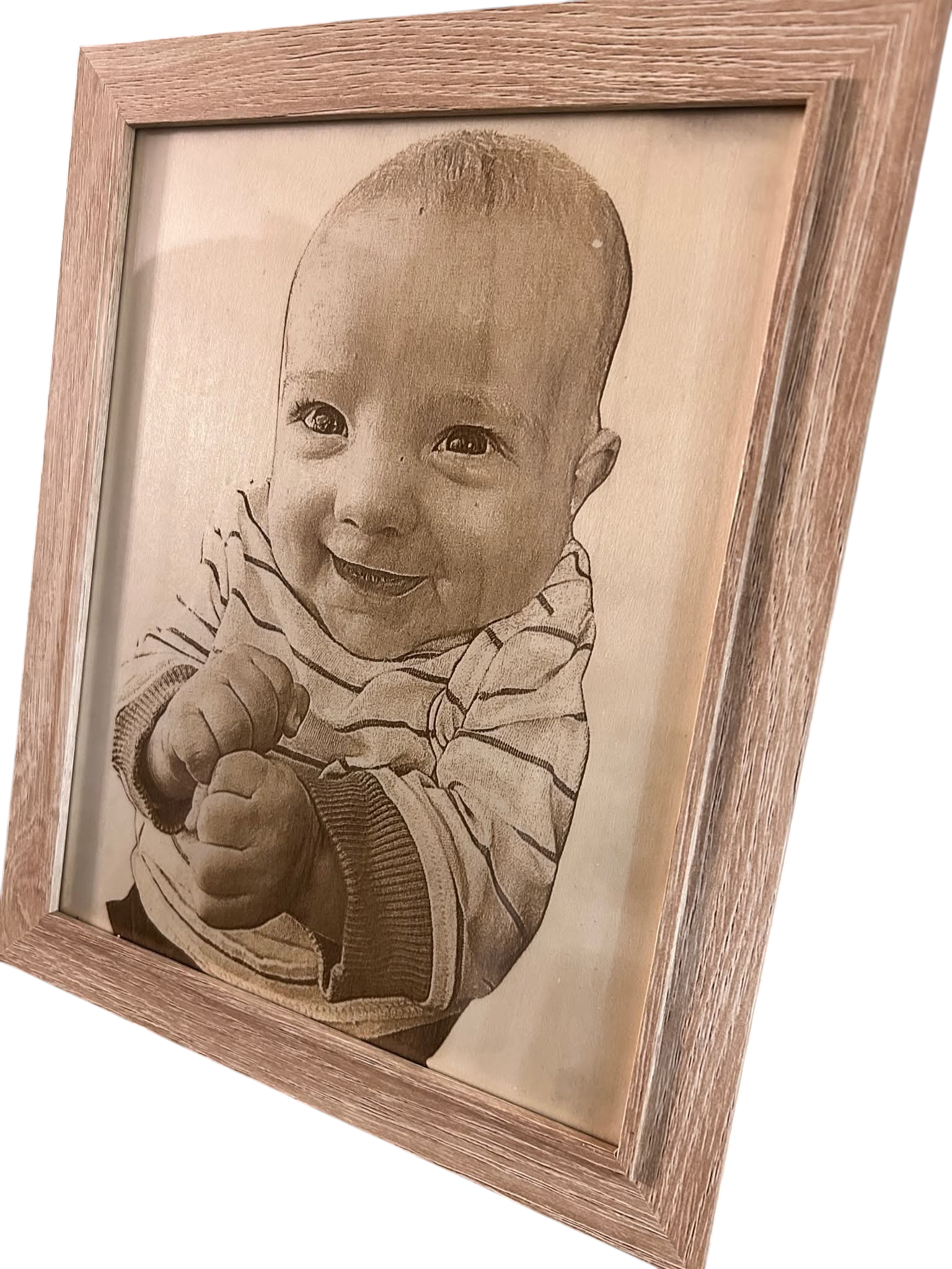 Laser engraved photo of a families first born grandchild on wood.
