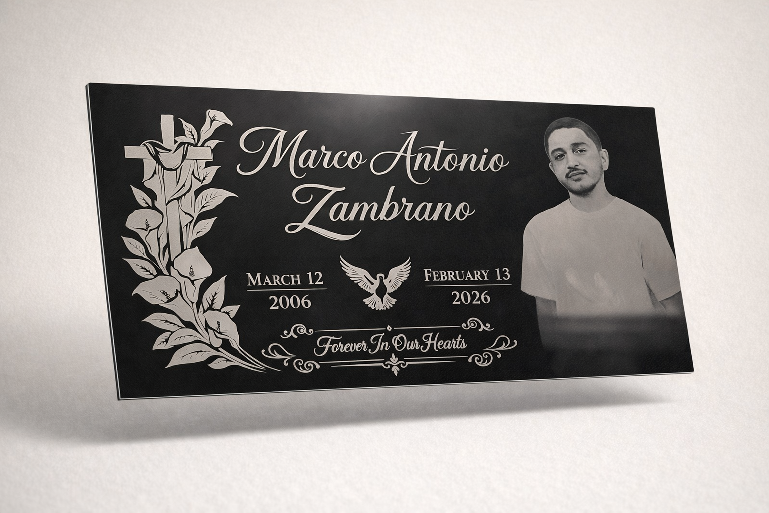 Memorial plaque for Marco Antonio Zambrano with dates March 12, 2006, to February 13, 2026, featuring a black background, white text, a dove with wings spread, a floral design, and a photo of a young man in a plain shirt.