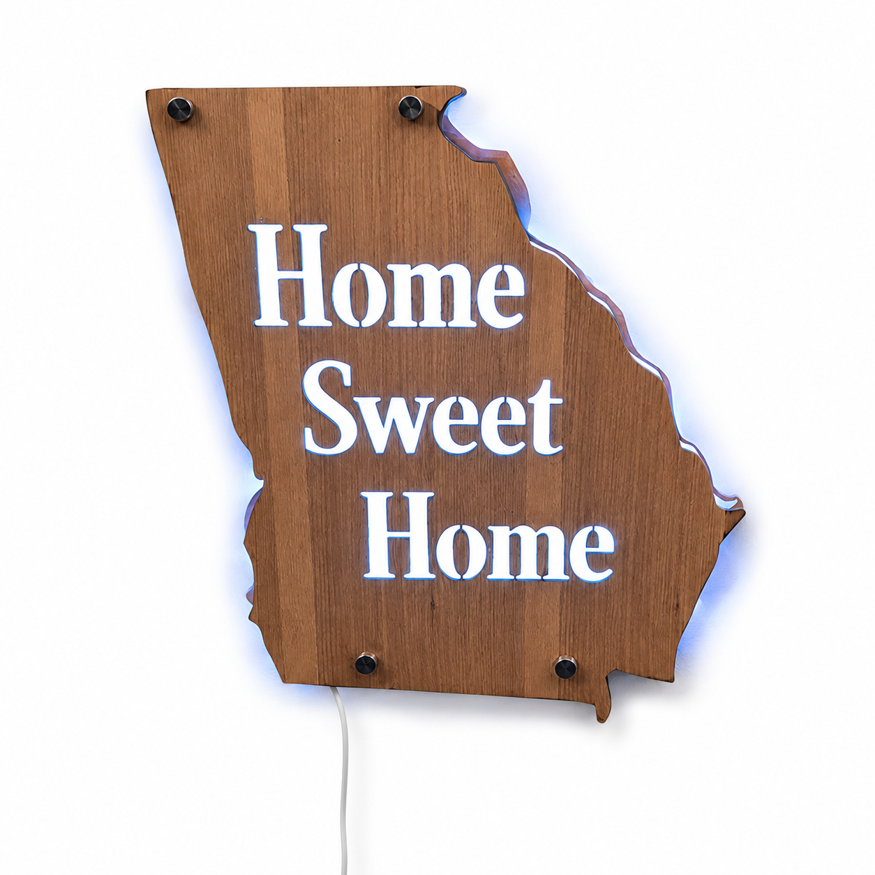 Wooden sign in the shape of the state of Georgia with the words 'Home Sweet Home' in white illuminated letters.