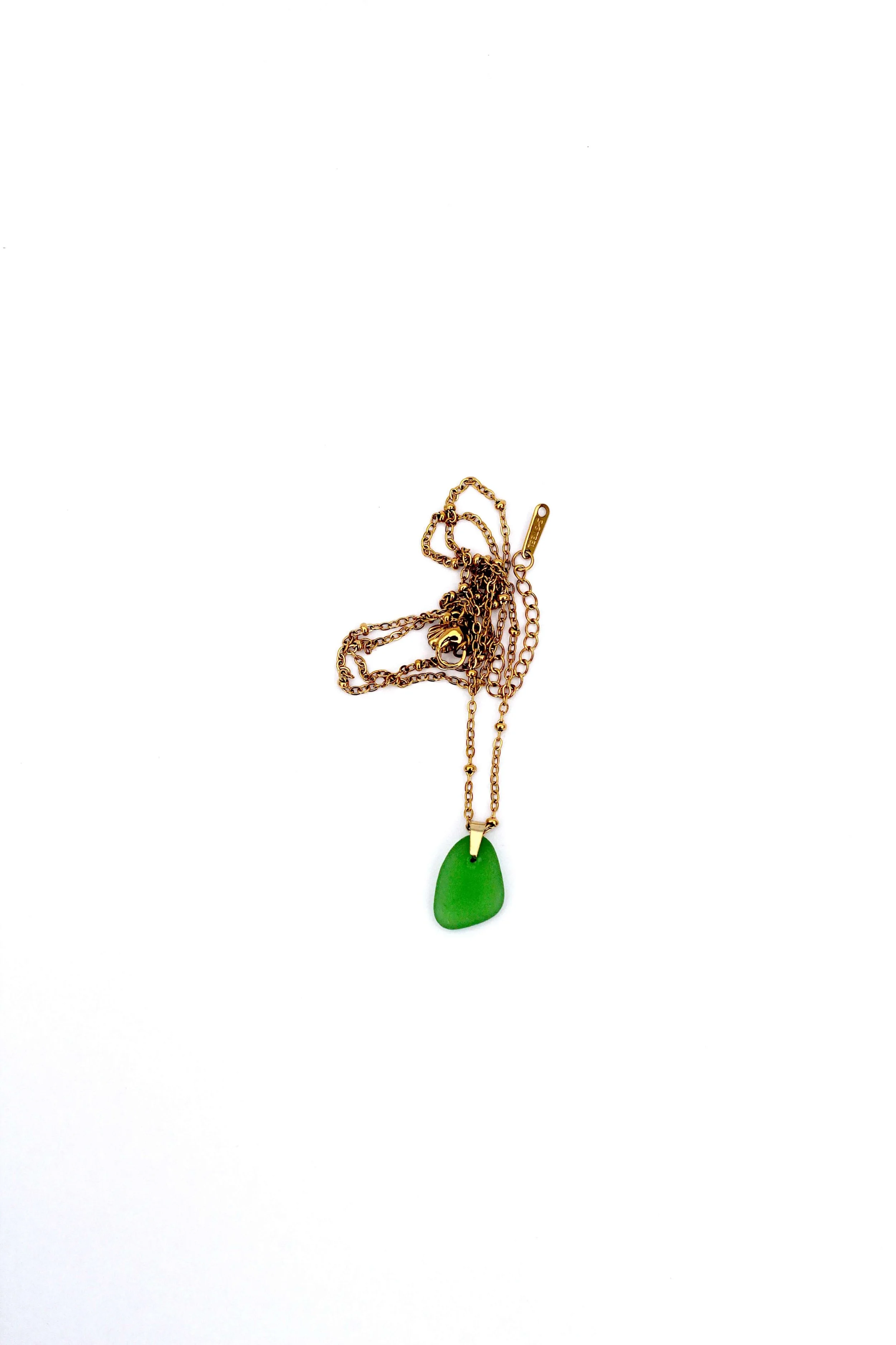 A genuine ocean-tumbled green sea glass pendant on an 18K gold-plated stainless steel cable chain necklace on a white background.