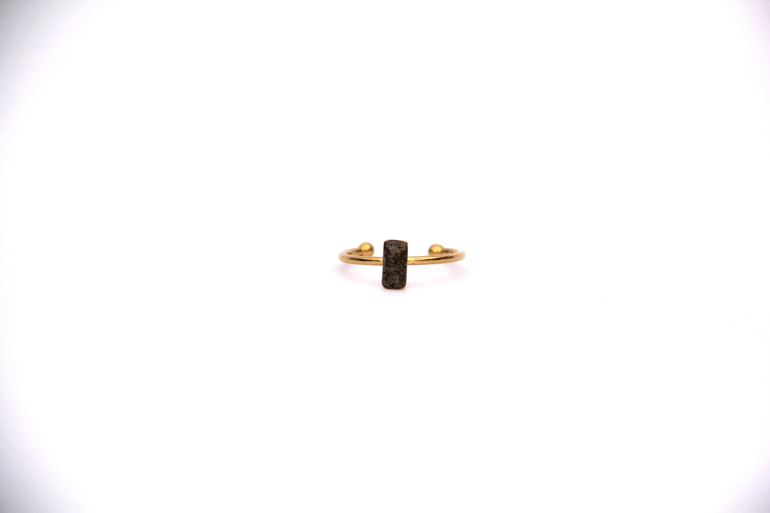 The front of a genuine hand collected beach sand ring on a white background.