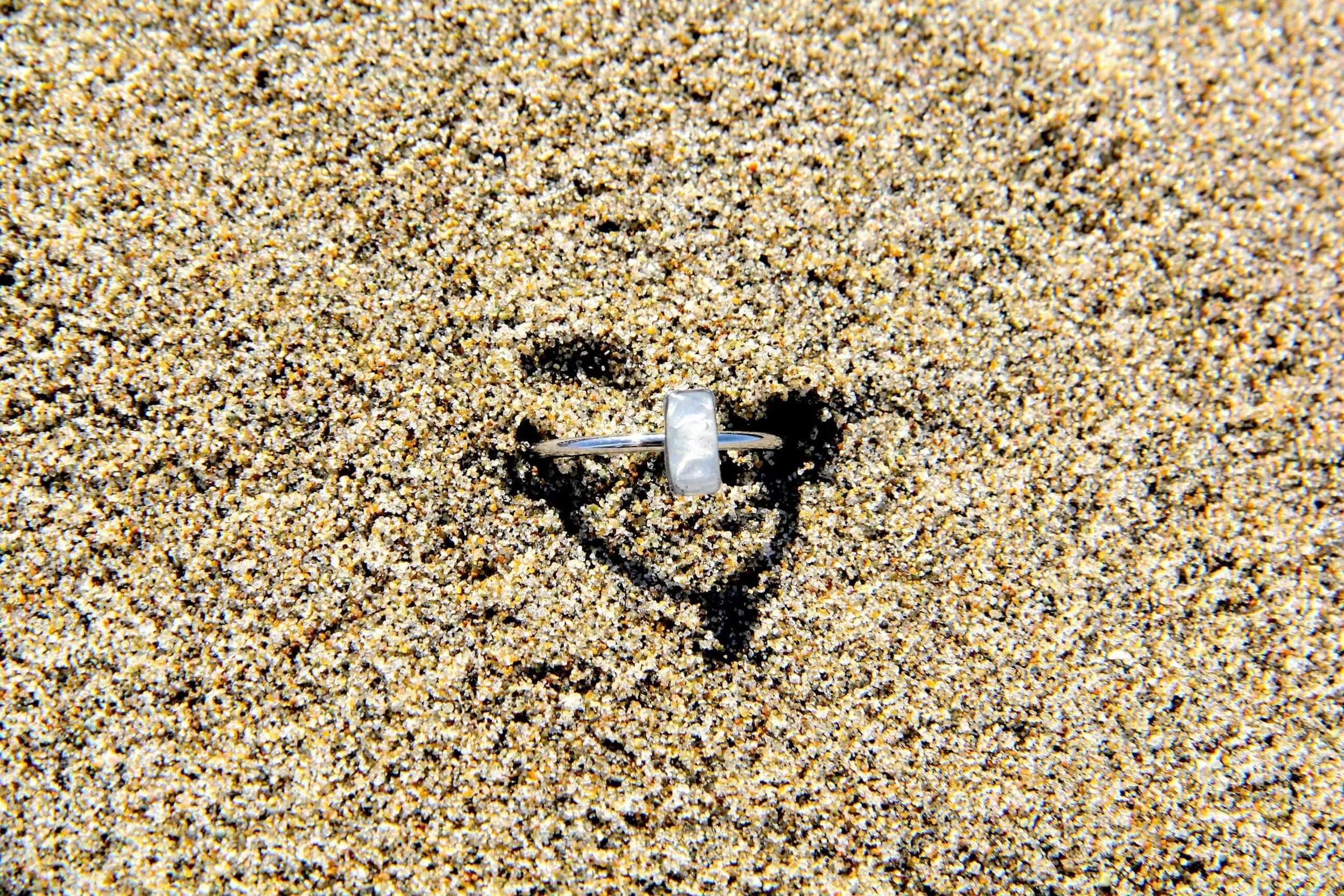 A genuine hand collected sea salt ring lying in beach sand.