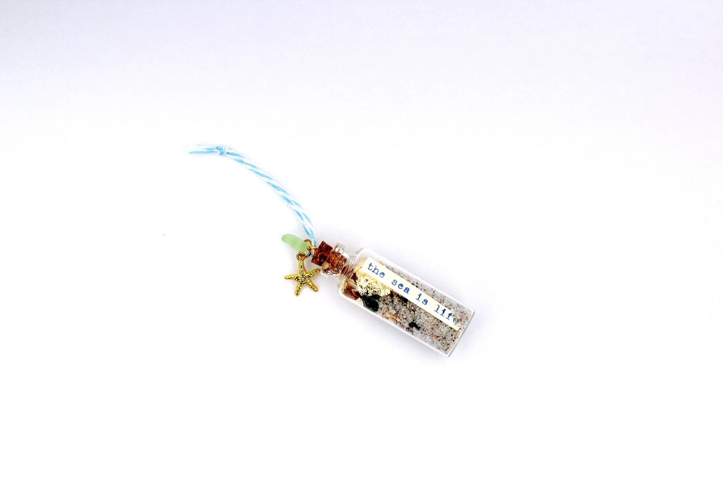The Starfish Beach in a Bottle Ornament on a white background.
