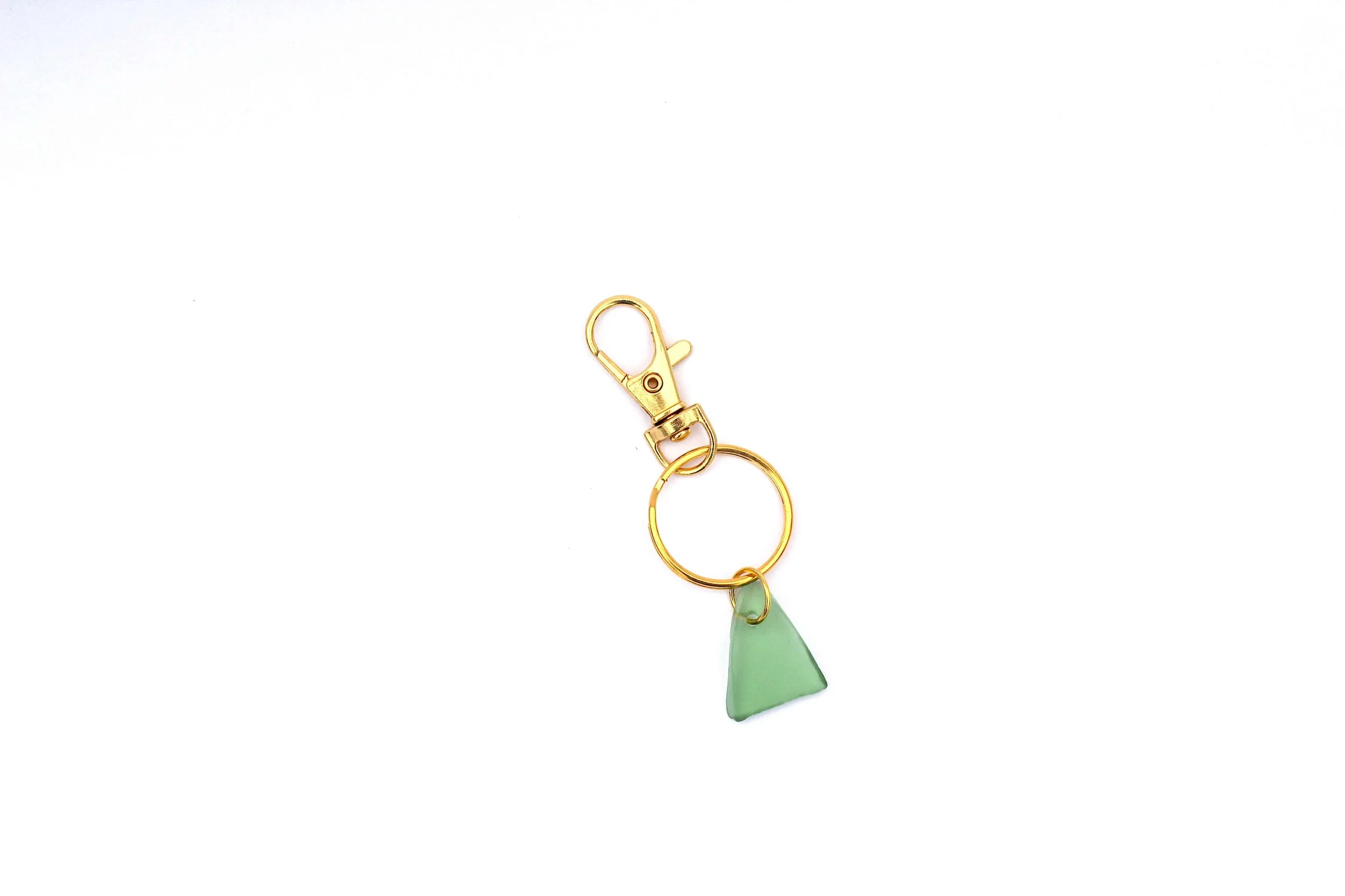 A genuine ocean-tumbled sea glass keychain on a white background.