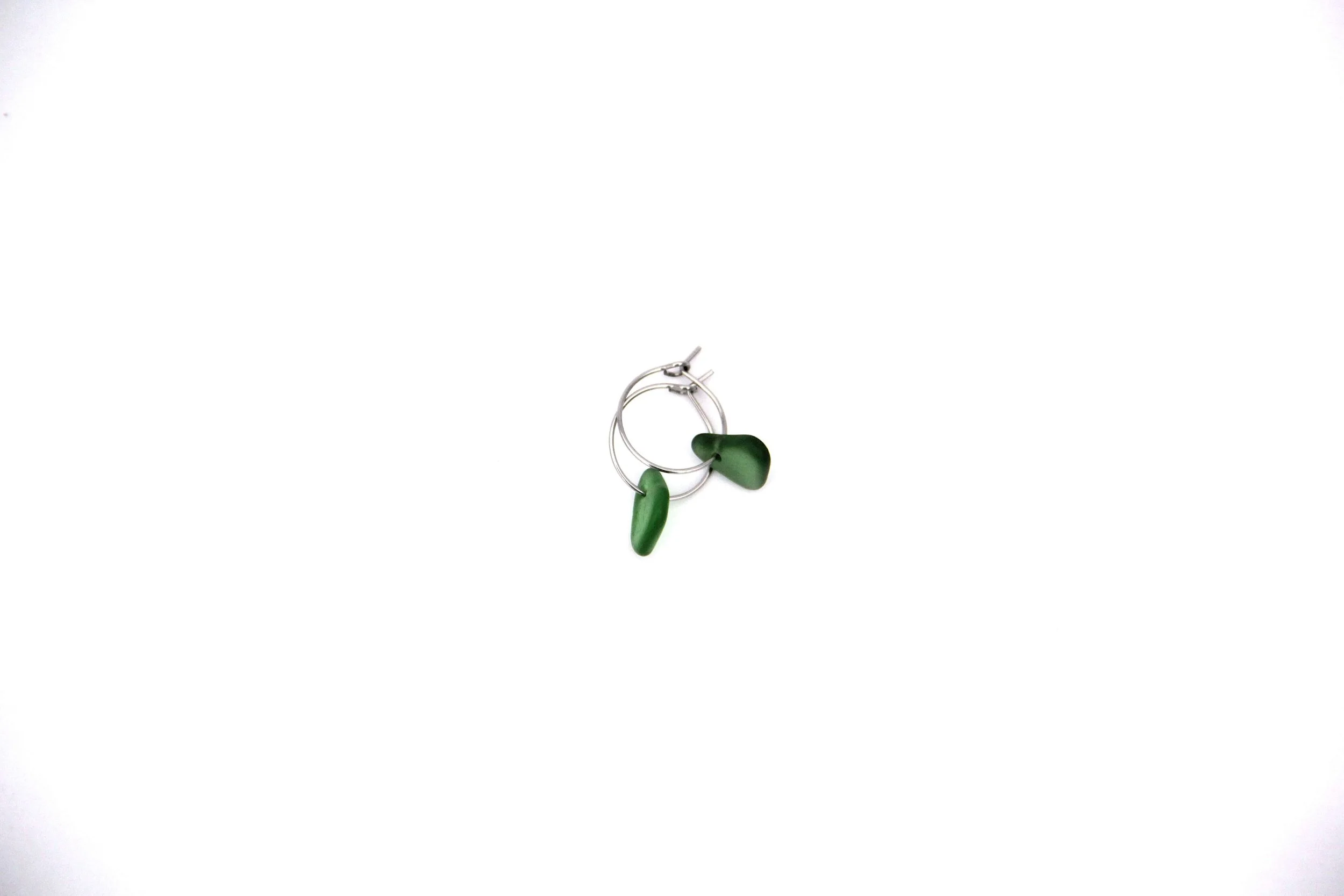 Silver stainless steel sea glass hoop earrings on white background.