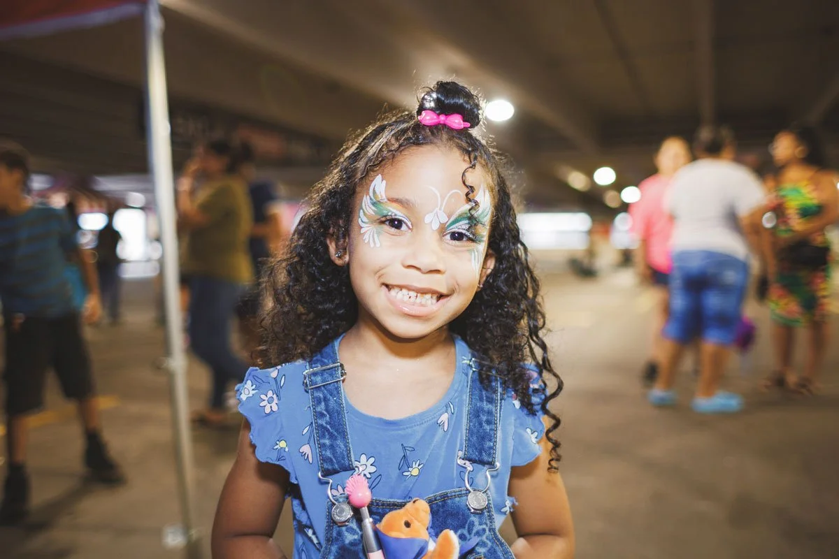 Face-Painter_Girl-Smiling-Holding-Toys-1200.jpg