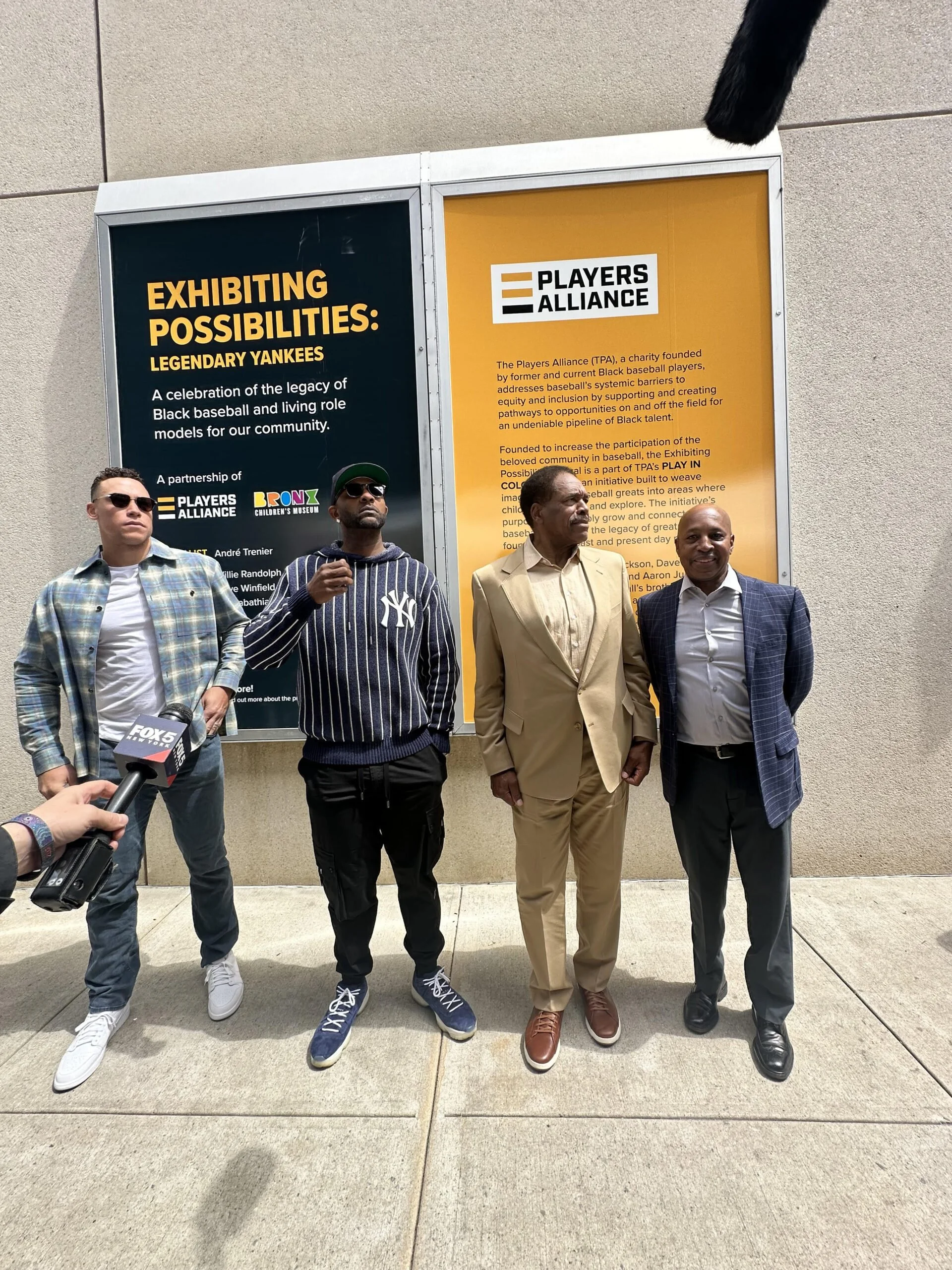 Aaron Judge, CC Sabathia, Dave Winfield, Willie Randolph in Front of Exhibit Label