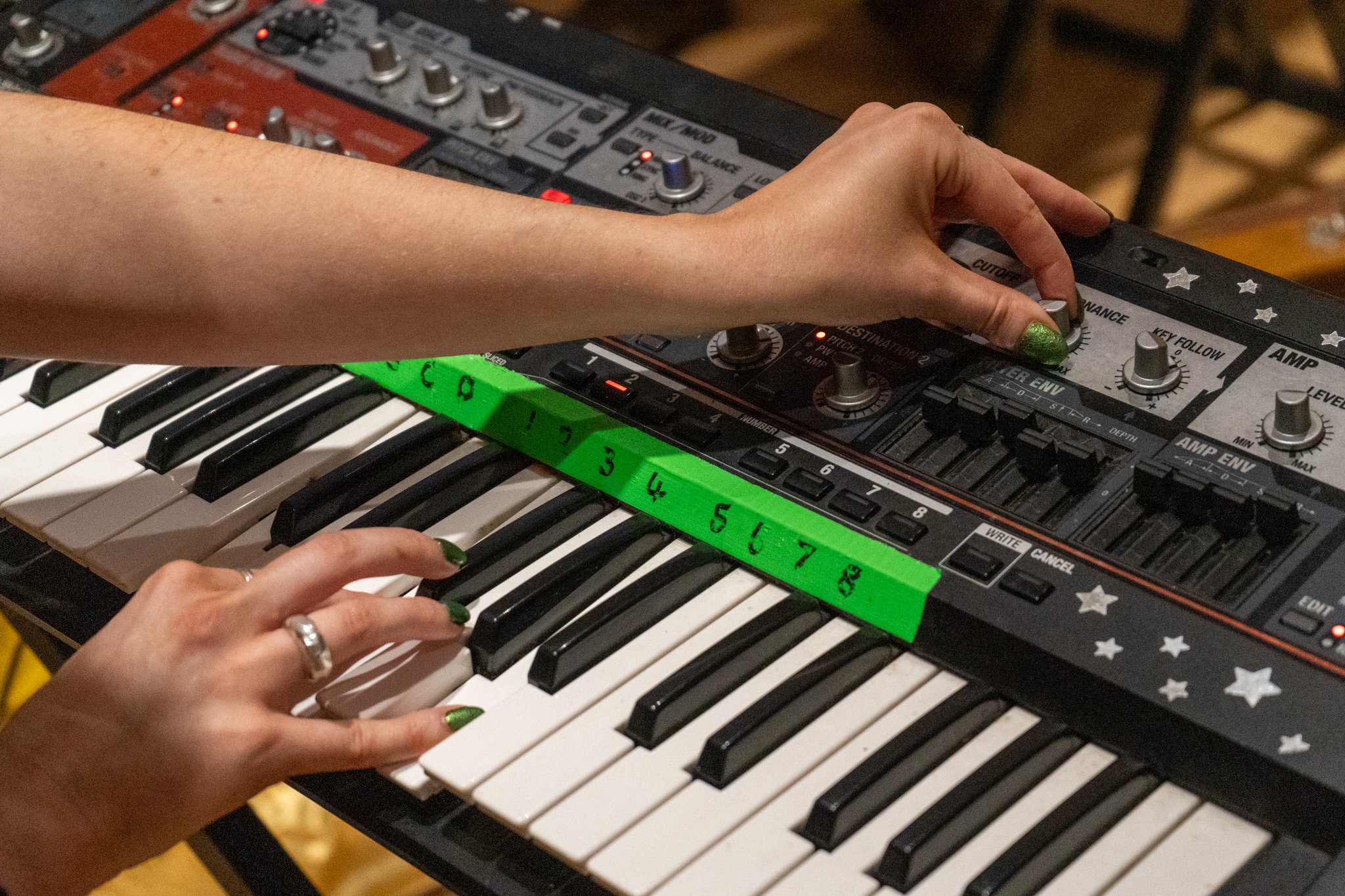 A pair of hands playing a keyboard