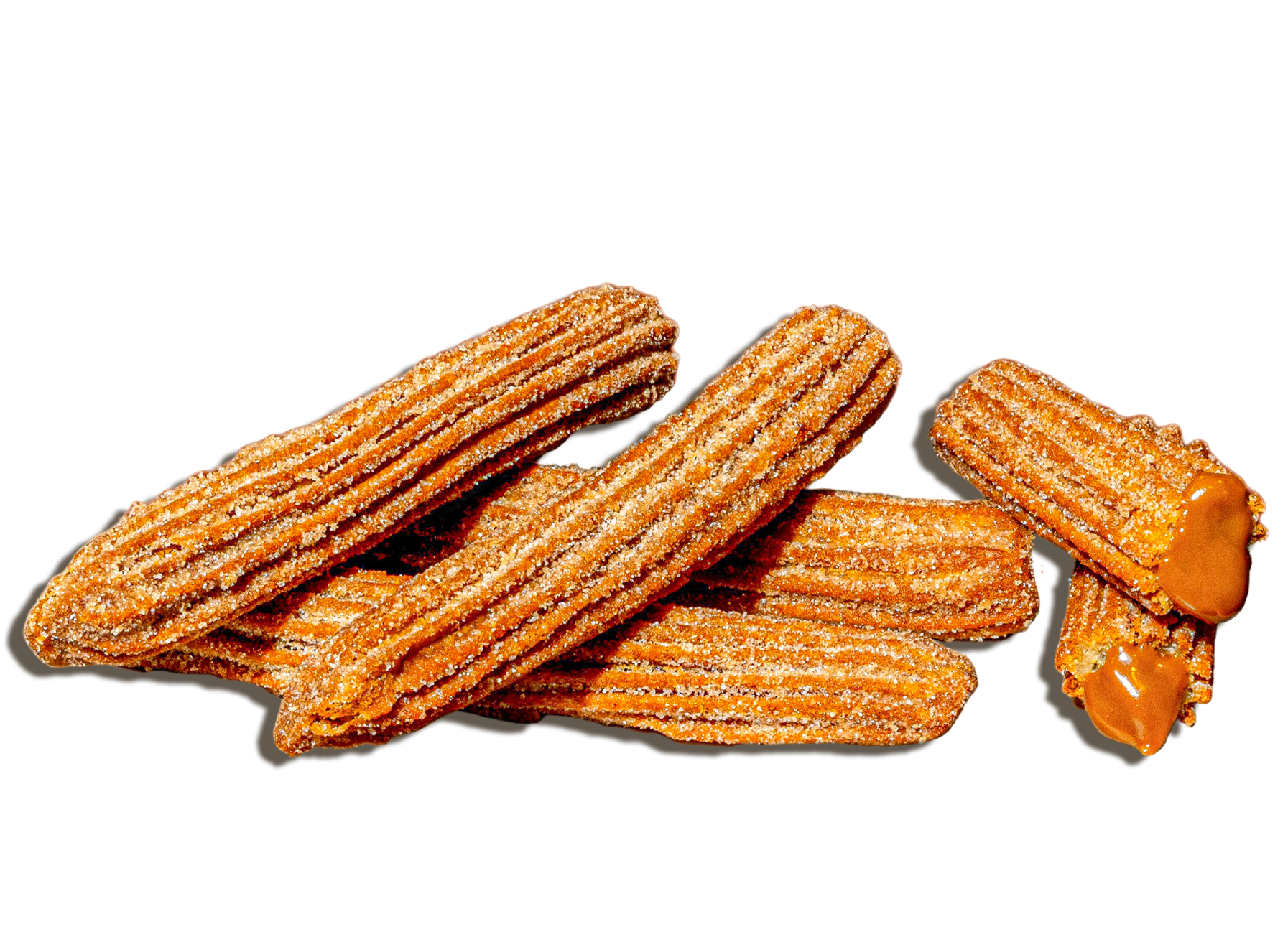 Group of churros coated with sugar, some filled with caramel sauce.