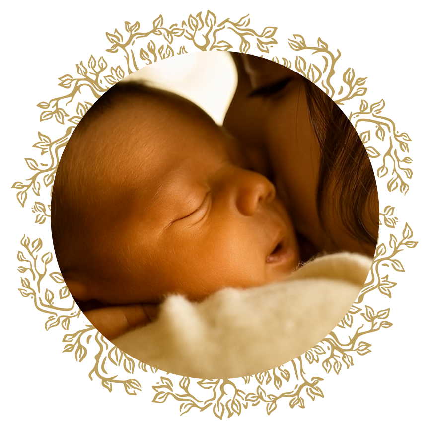 A mother gently kissing her newborn baby on the forehead.