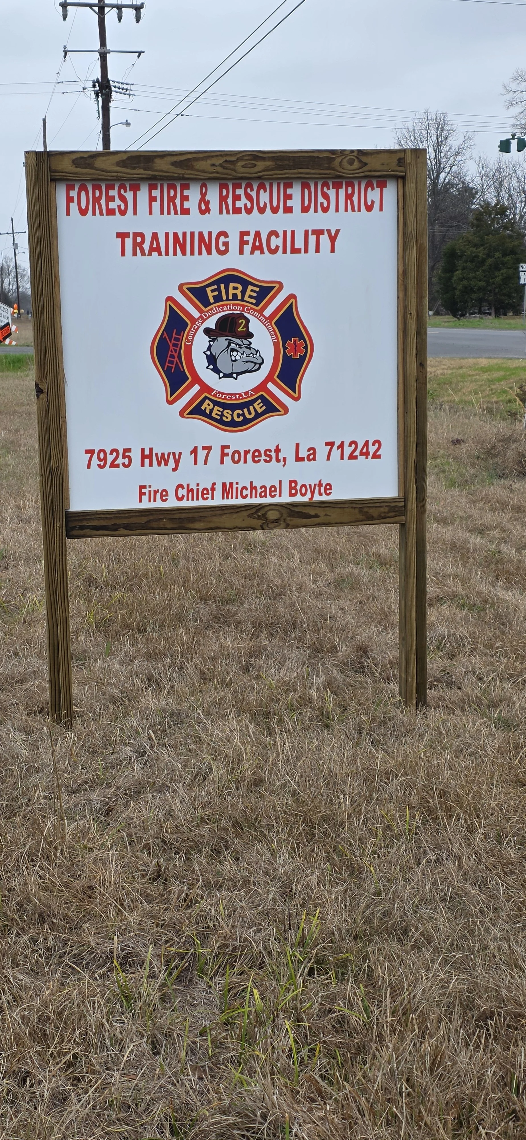 Sign for Forest Fire & Rescue District Training Facility in Forest, Louisiana, with address 7925 Hwy 17, featuring the fire department emblem and contact information.