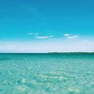Turquoise ocean and blue sky, a personal travel photo shared by Sophia Park McKenna.