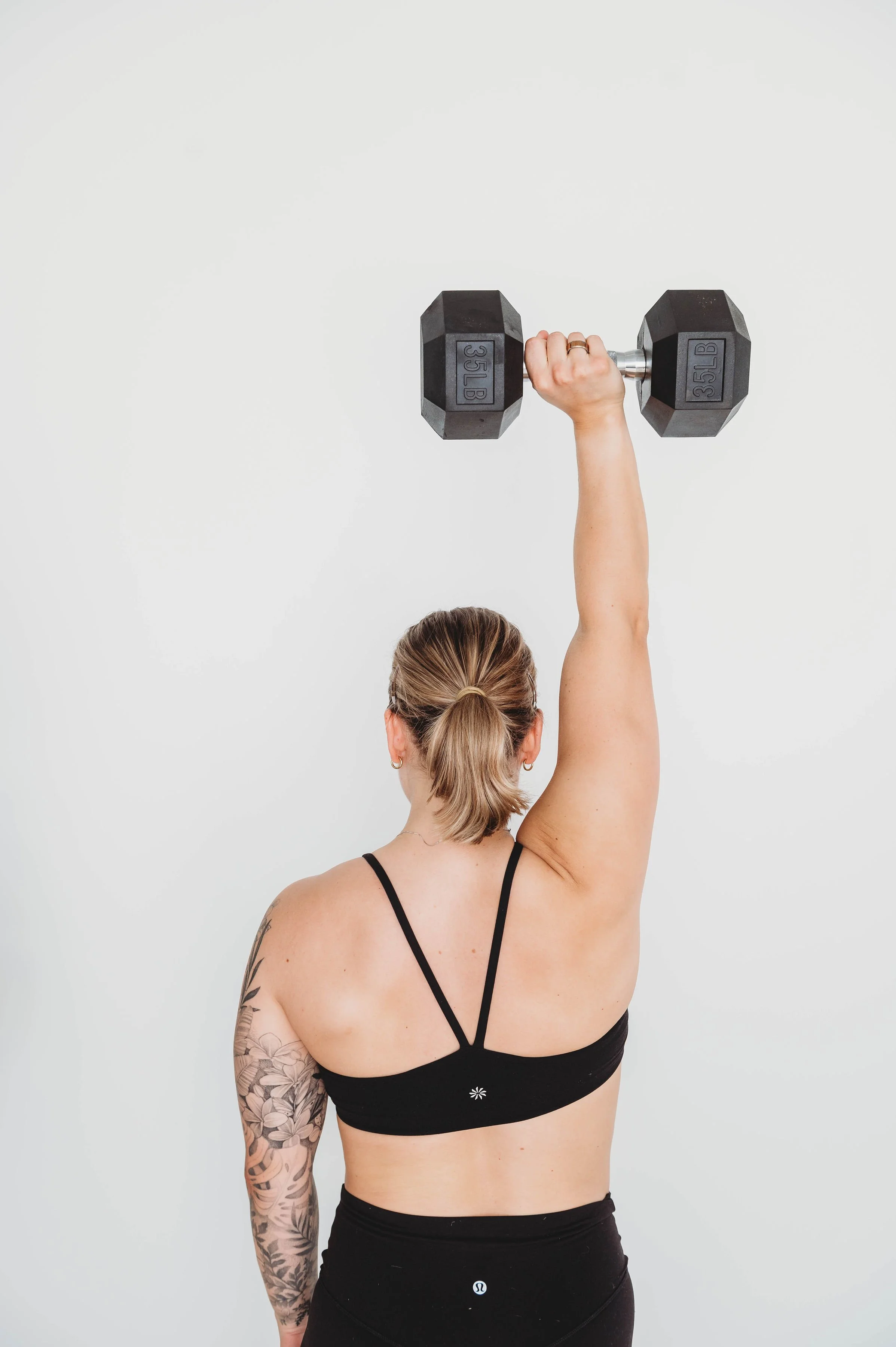 Strength and conditioning exercise with a dumbbell for active rehabilitation at Larch House Physio & Movement in Stittsville.