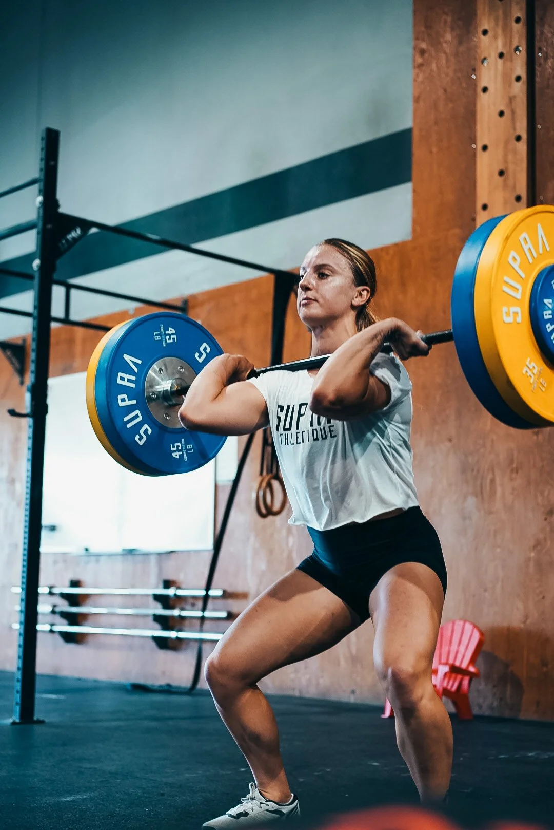 Freya Moosbrugger performing an Olympic weightlifting movement, reflecting her background in competitive strength and conditioning.