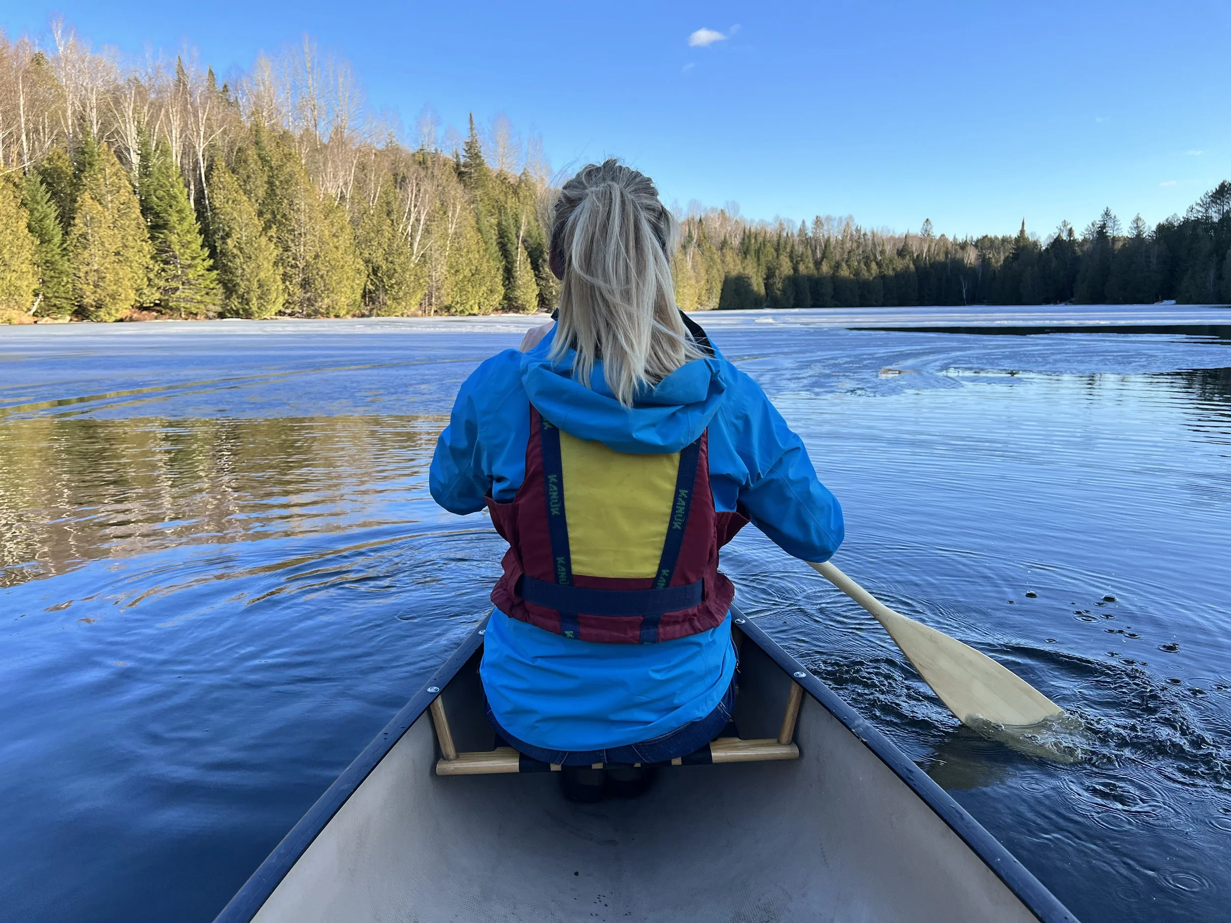 Sally Lygo kayaking on a lake, reflecting her active lifestyle and love of outdoor recreation.