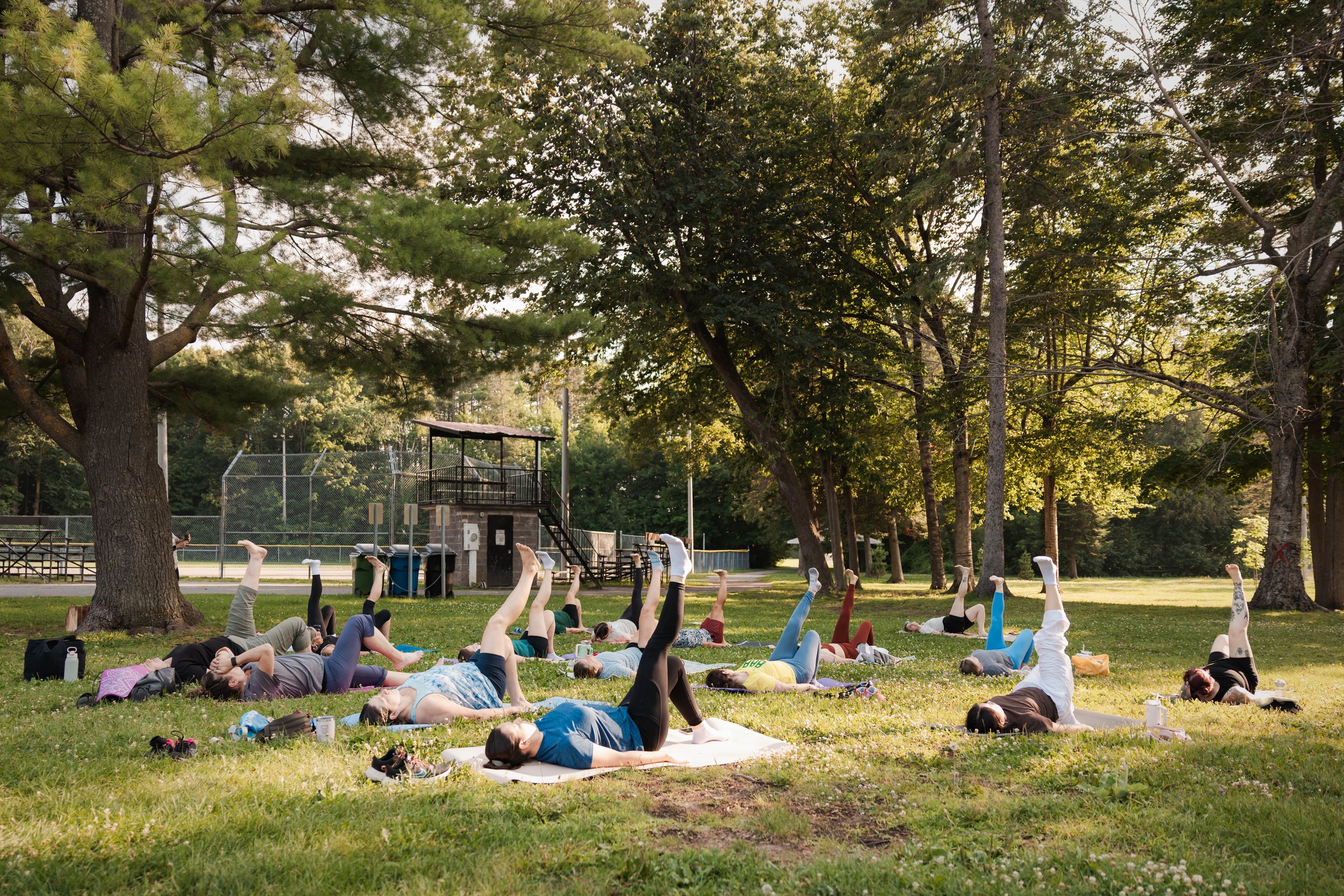 Participants enjoying a free outdoor community Pilates class in Stittsville, Ottawa, led by Larch House Physio & Movement to promote health, mobility, and community connection.