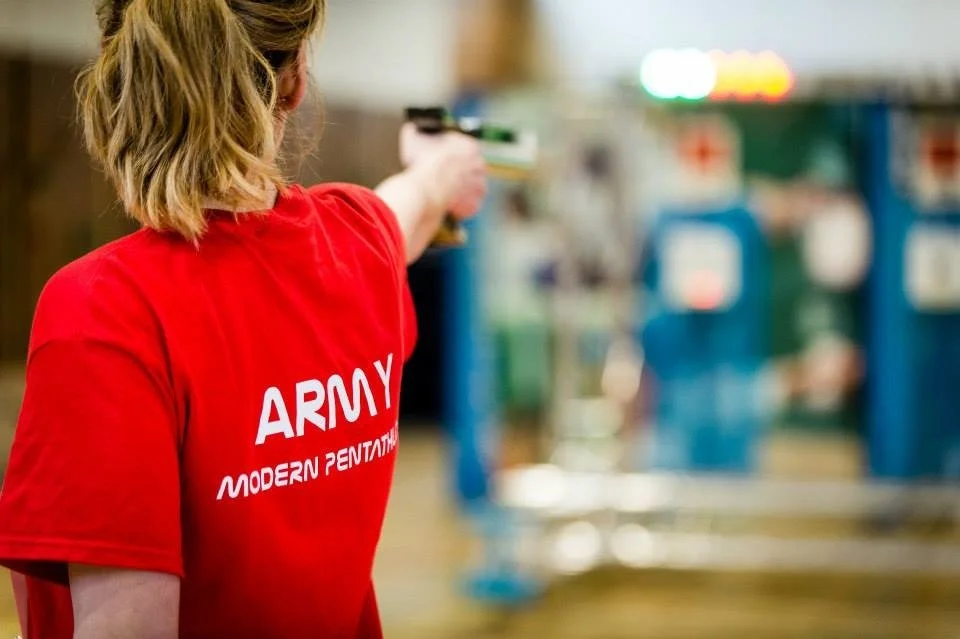 Sally Lygo competing in the shooting discipline of modern pentathlon, reflecting her background in competitive sport.