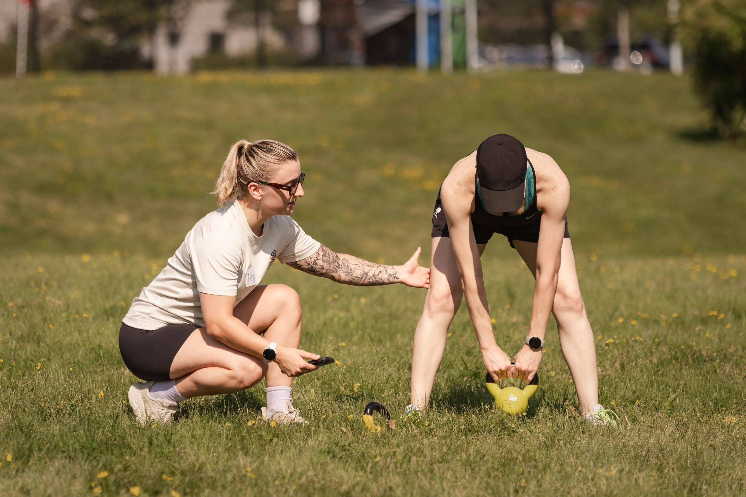 Freya Moosbrugger coaching strength and conditioning during an outdoor small-group workout.