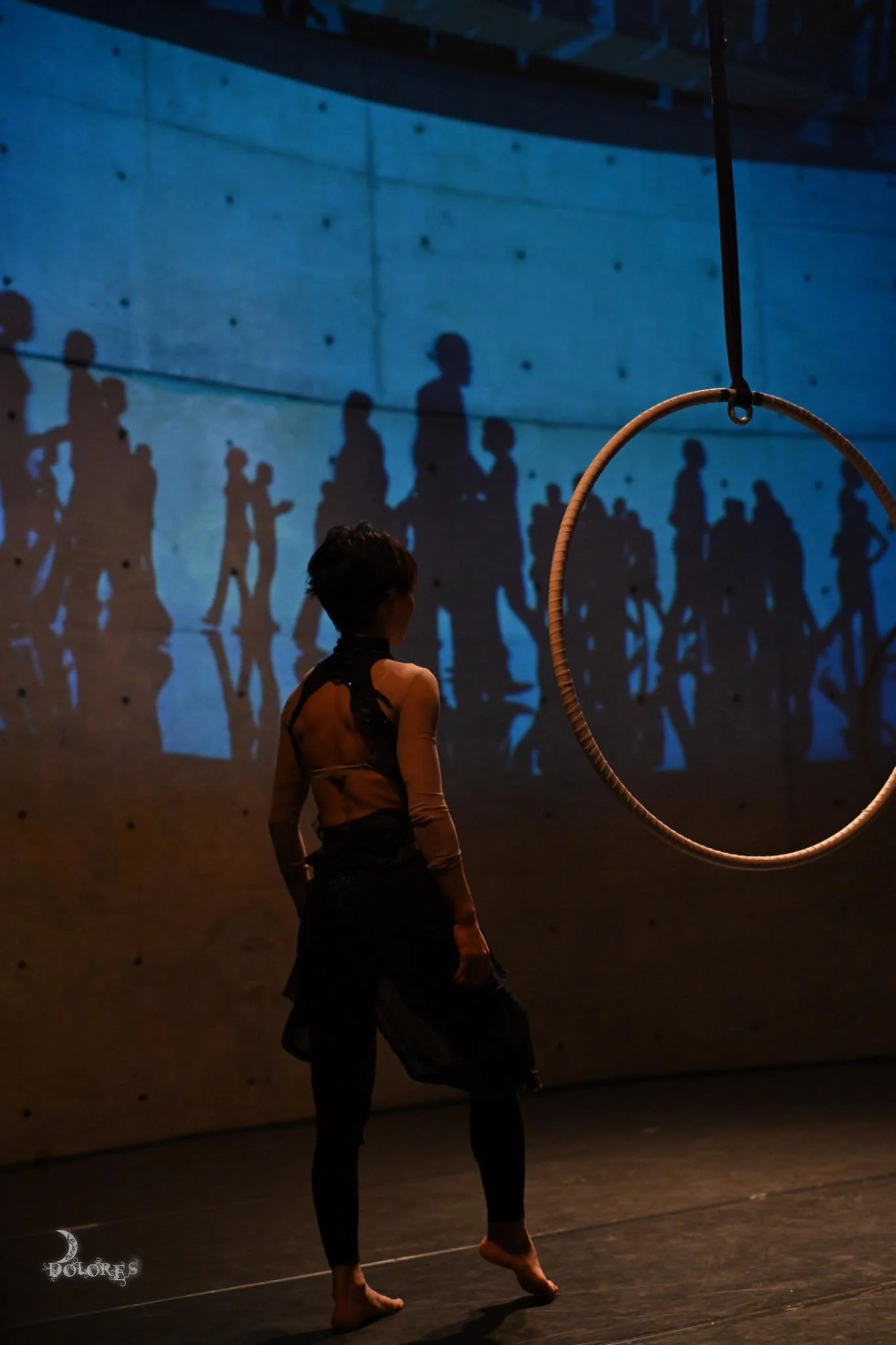 Scene from Whale in the Deep Sea. Through aerial performance and projected imagery, the work depicts an encounter between a solitary human figure and the symbolic presence of a whale.