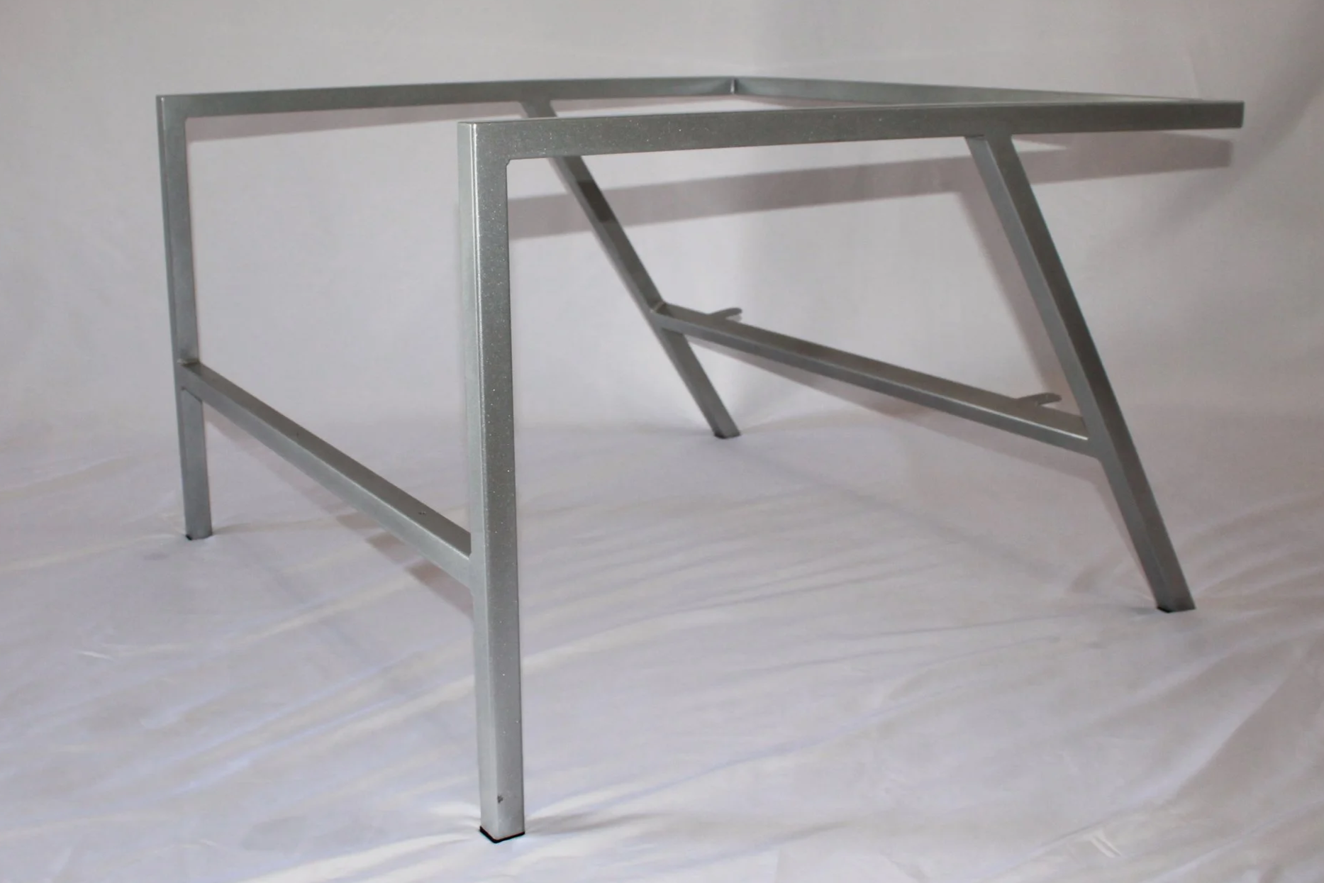 Silver metal chair , set against a plain white background.