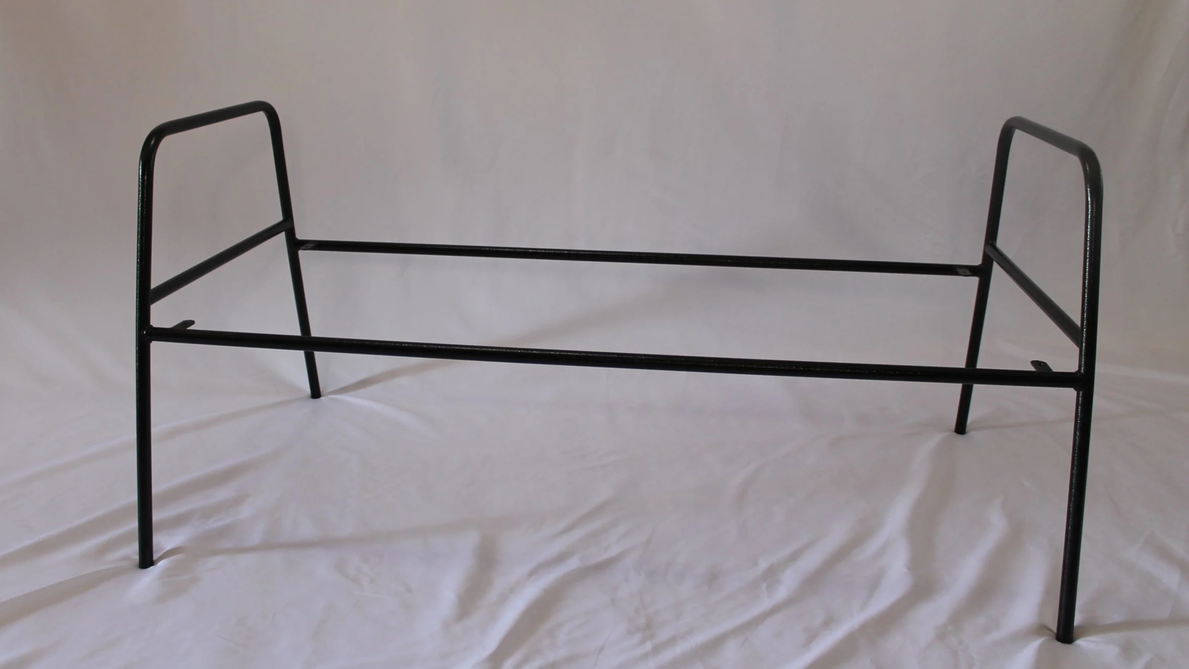 A black metal loveseat frame, shown against a plain white background.