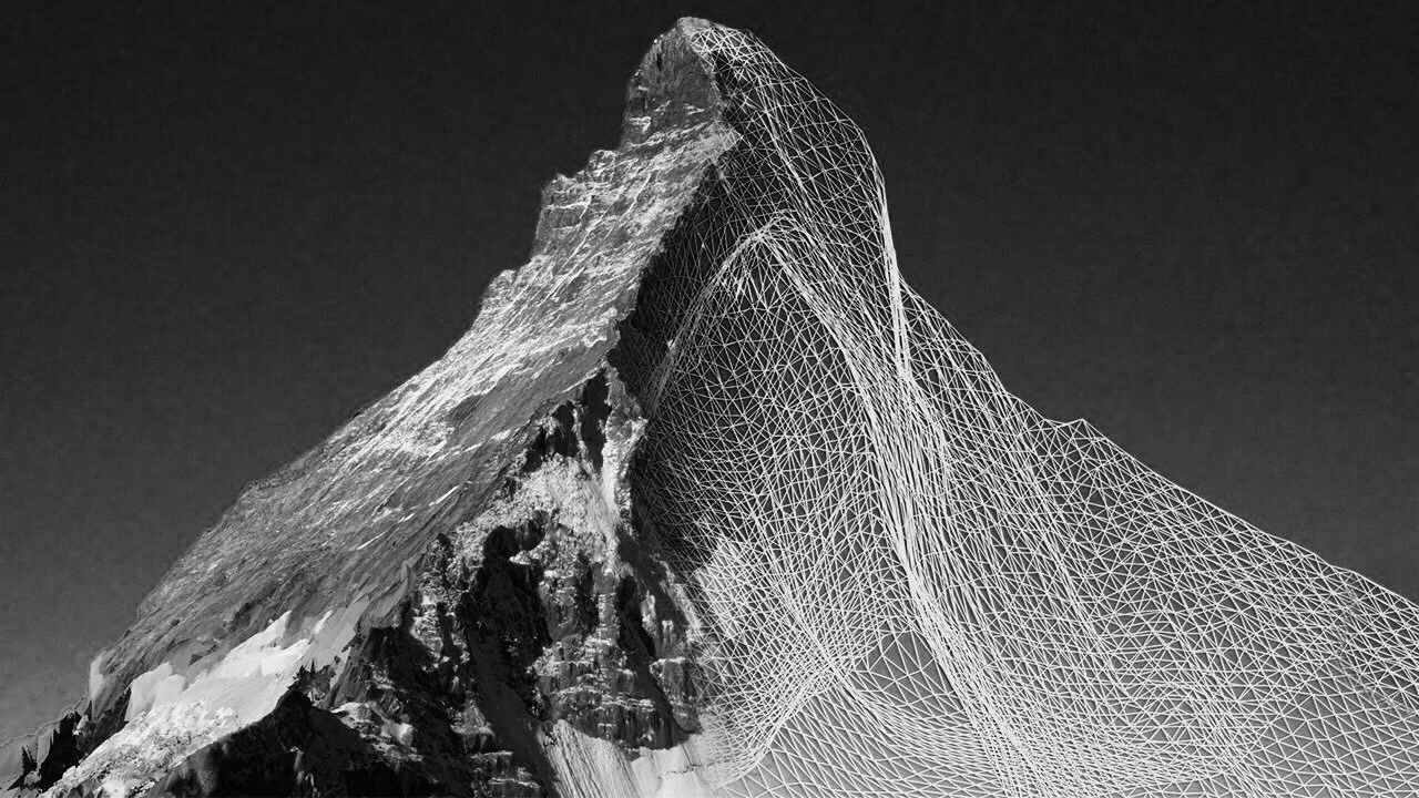 Black and white photo of a mountain with a digital wireframe overlay.