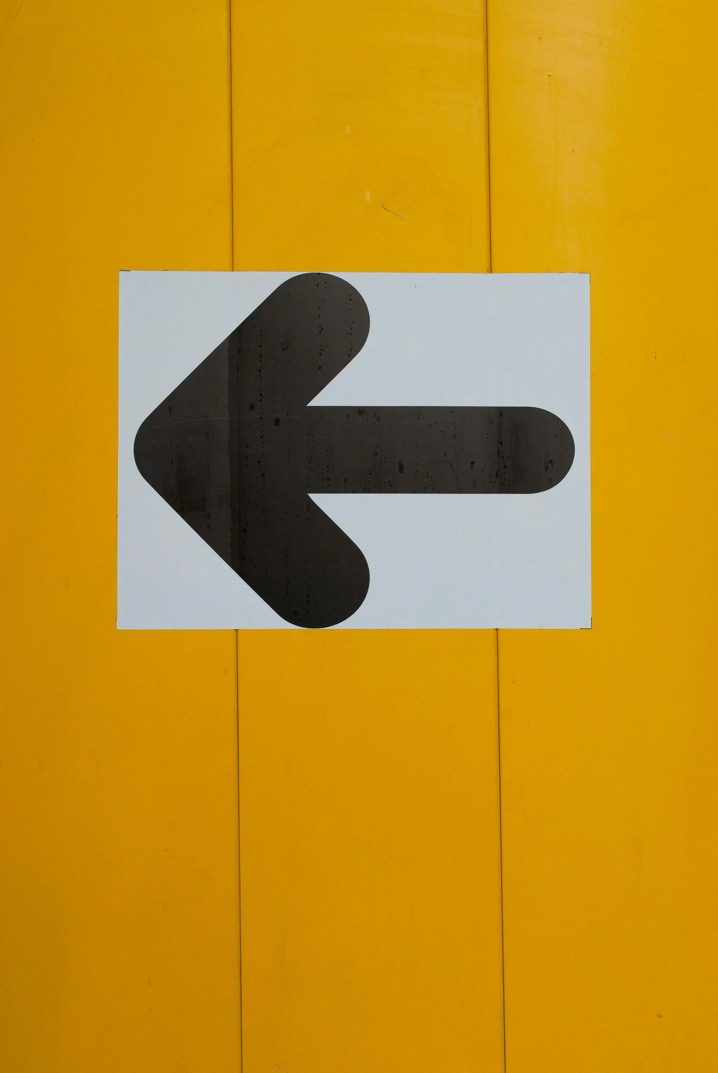 Black arrow on yellow background