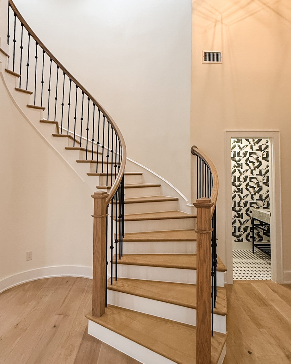 after image of renovated, modern white oak stairwell, with alcoves filled in