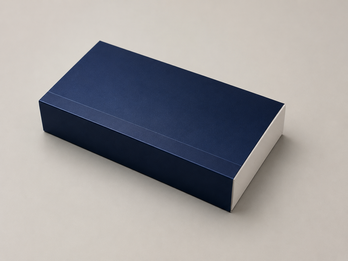 A rectangular navy blue box with a subtle texture is placed on a light gray surface.