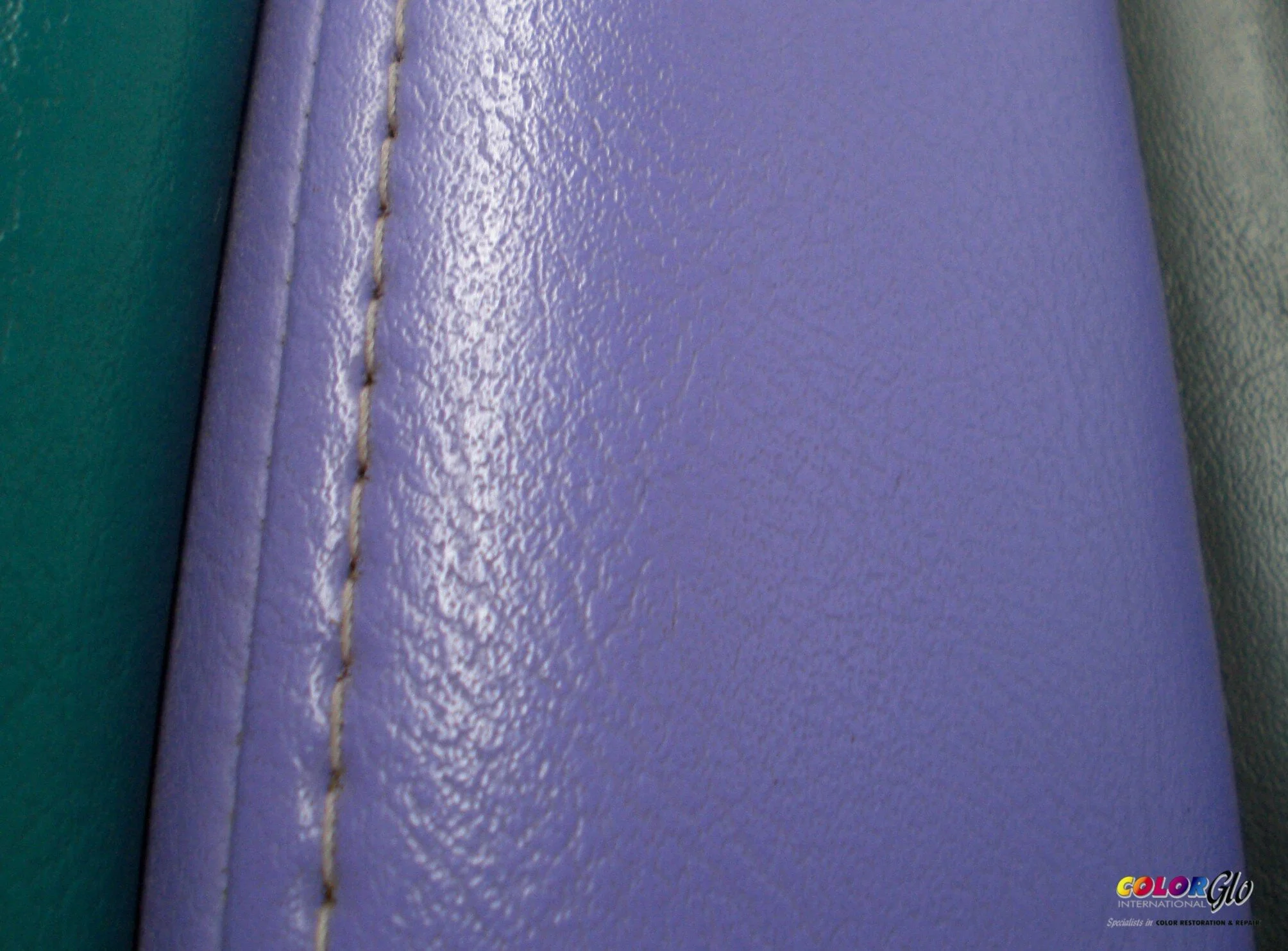 Close-up photo of a textured wall with lavender and green paint. The lavender wall has a vertical seam with visible stitching. A colorful logo for 'Color Glo' is visible in the bottom right corner.