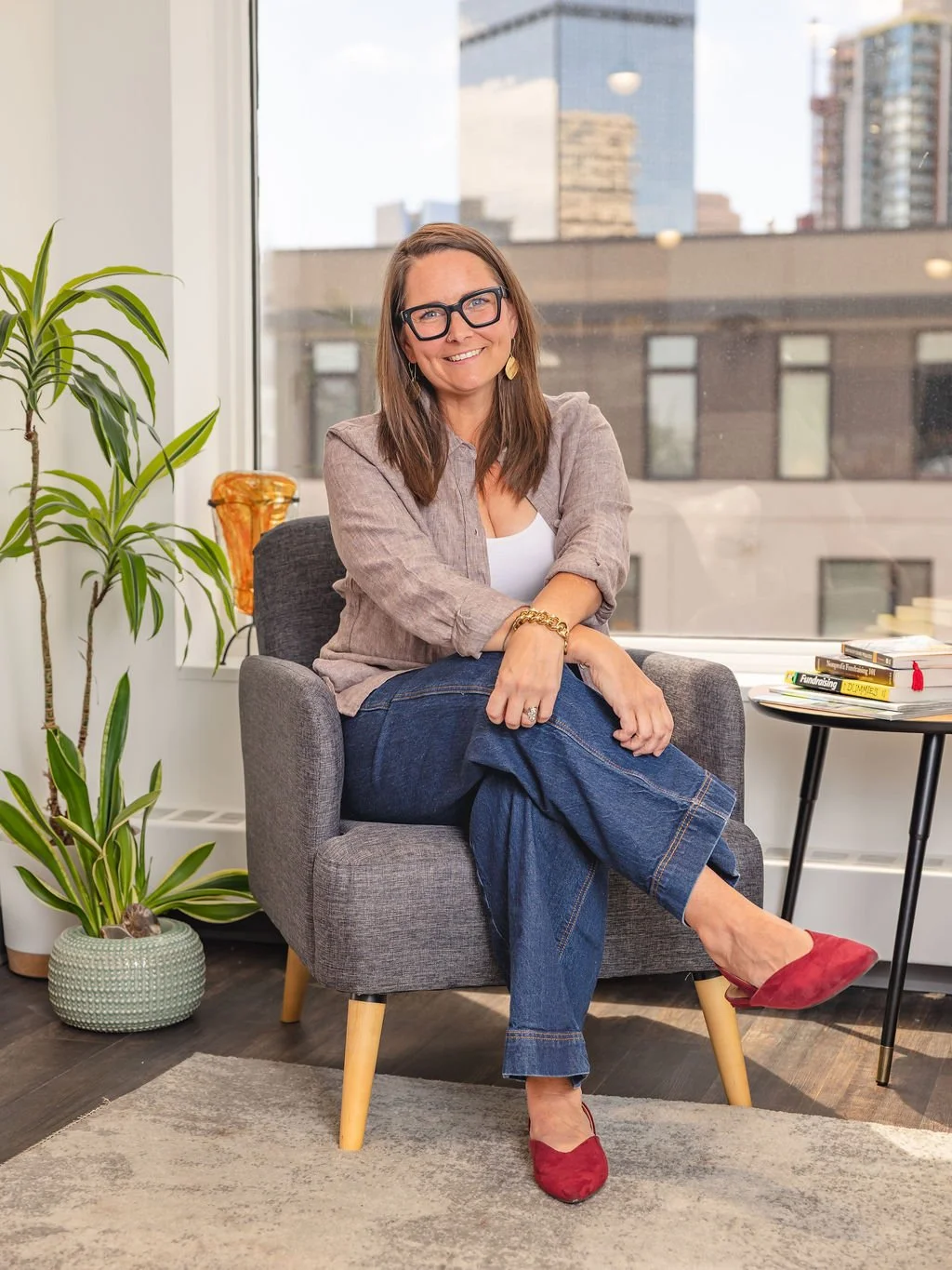 Courtney Schwartz, Recruitment specialist of Rooted hire sitting on a chair in an office setting