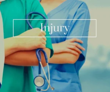 Two healthcare professionals in scrubs, one holding a stethoscope, with the word 'Injury' overlayed on the image.