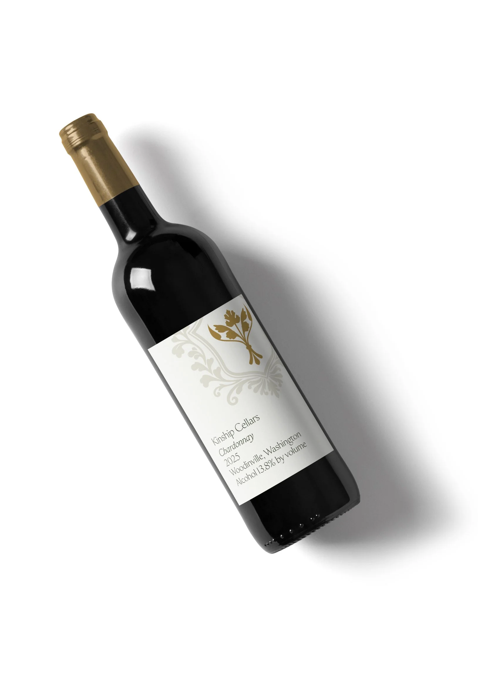 A bottle of red wine with a white label, gold capsule, and hanging corkscrew, placed diagonally on a white background.