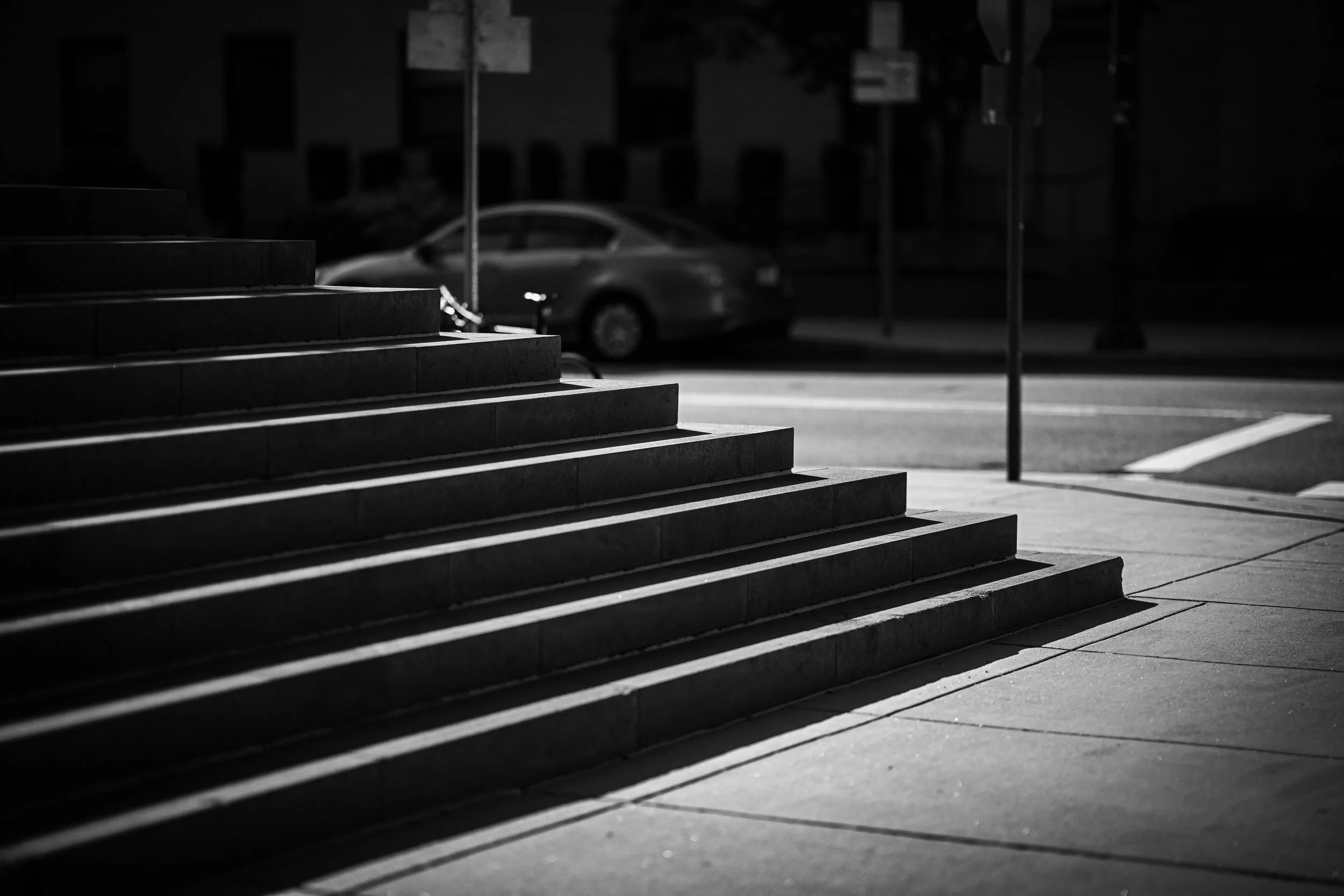 Sharp sunlight traces the edges of broad outdoor steps.