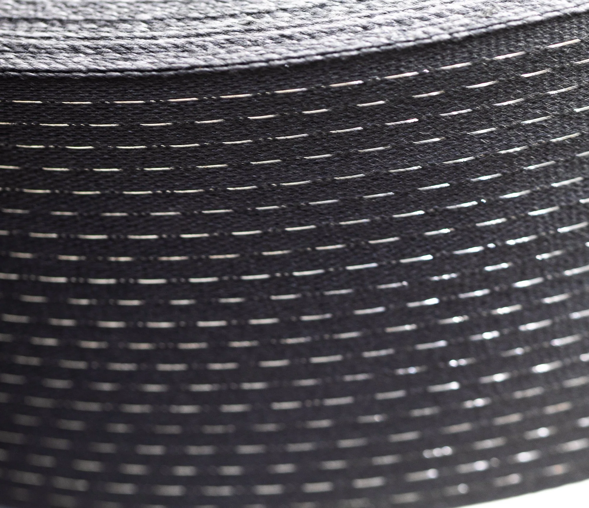 Close-up view of a textured black surface with small, evenly spaced white lines.