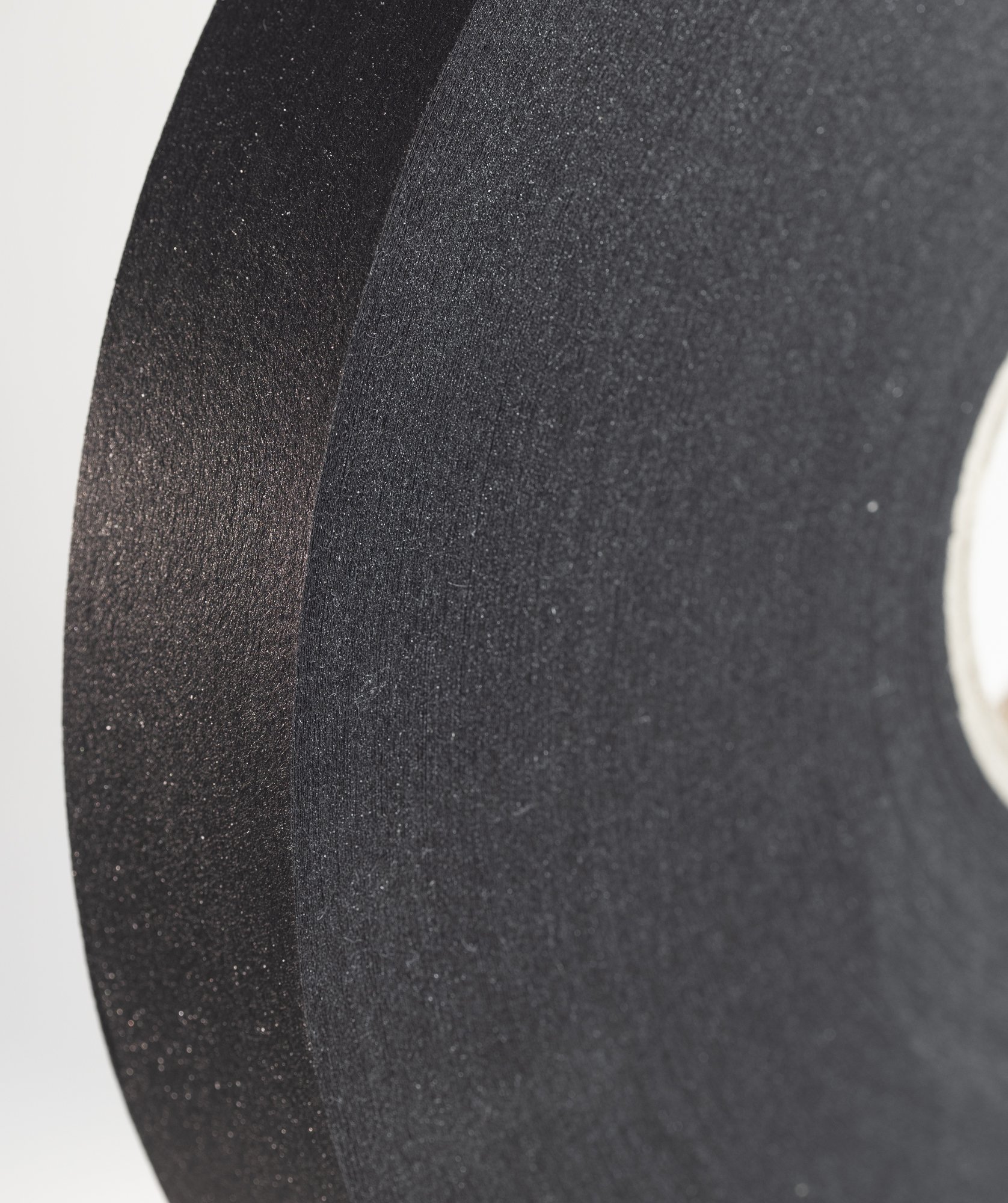 Close-up of a black surface with a textured, glittery finish.