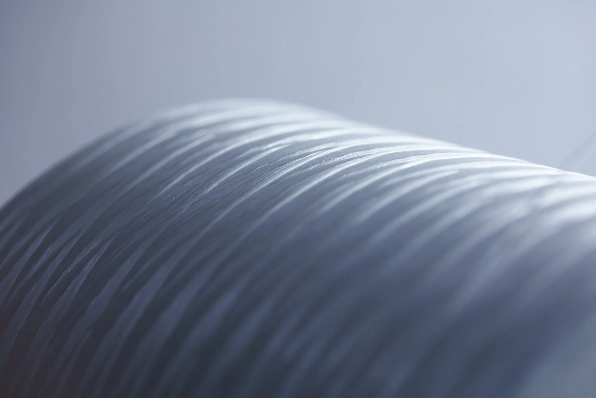 Close-up of a spiral-bound notebook or journal with metallic rings, captured in soft lighting.