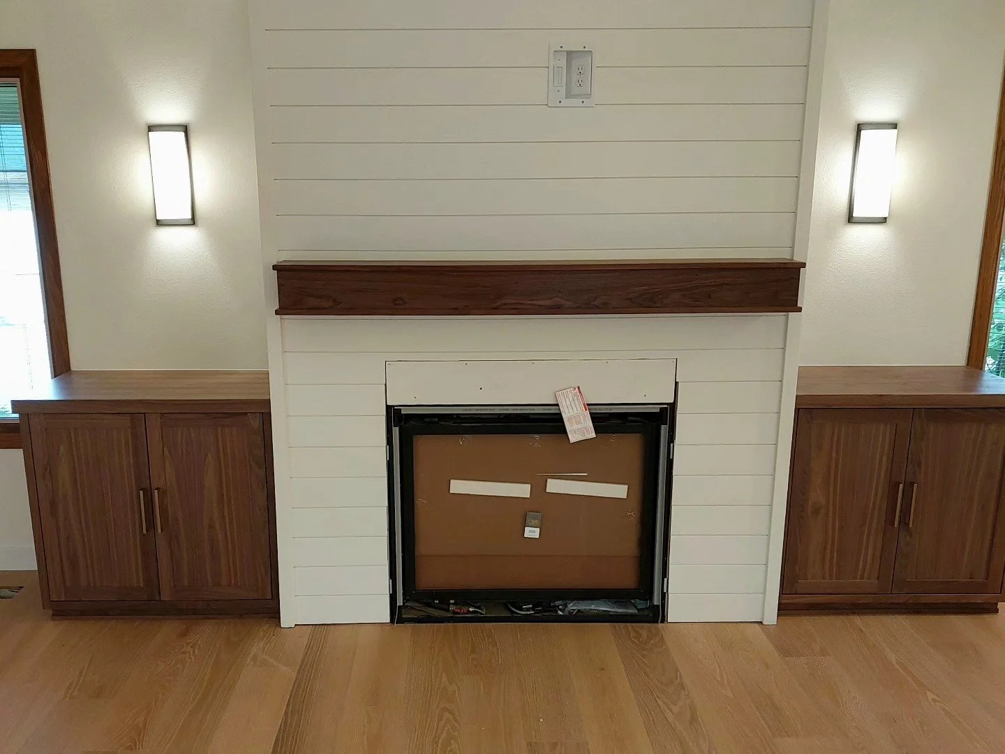 Waiting on the tile for around the fireplace to finish, fireplace build with walnut mantle and cabinets.