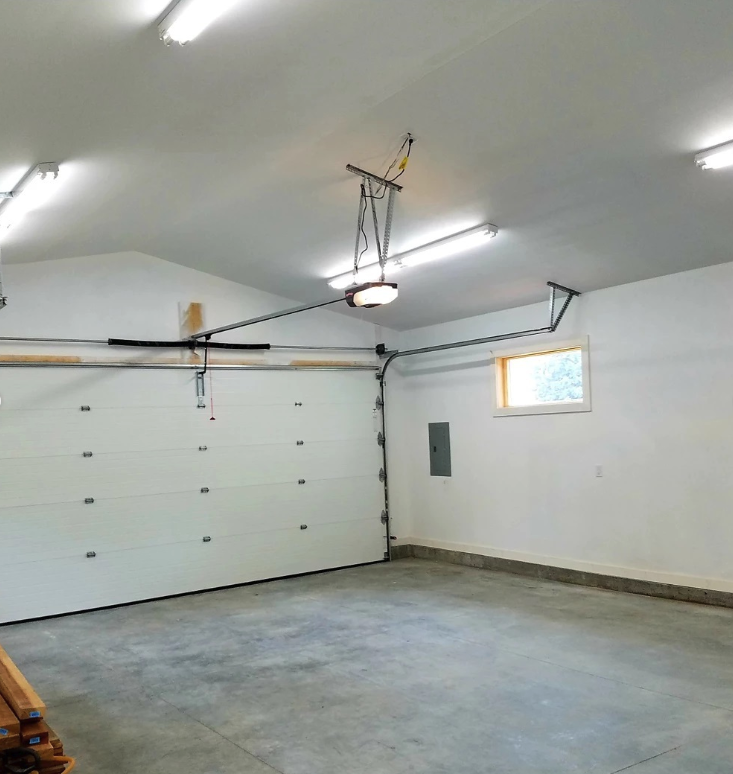 Interior of a 24'x30' garage with a concrete driveway and patio.