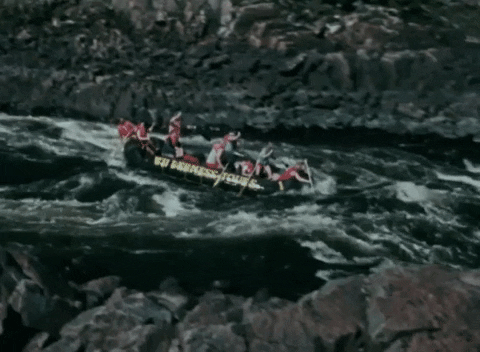 Group white water rafting over rapids