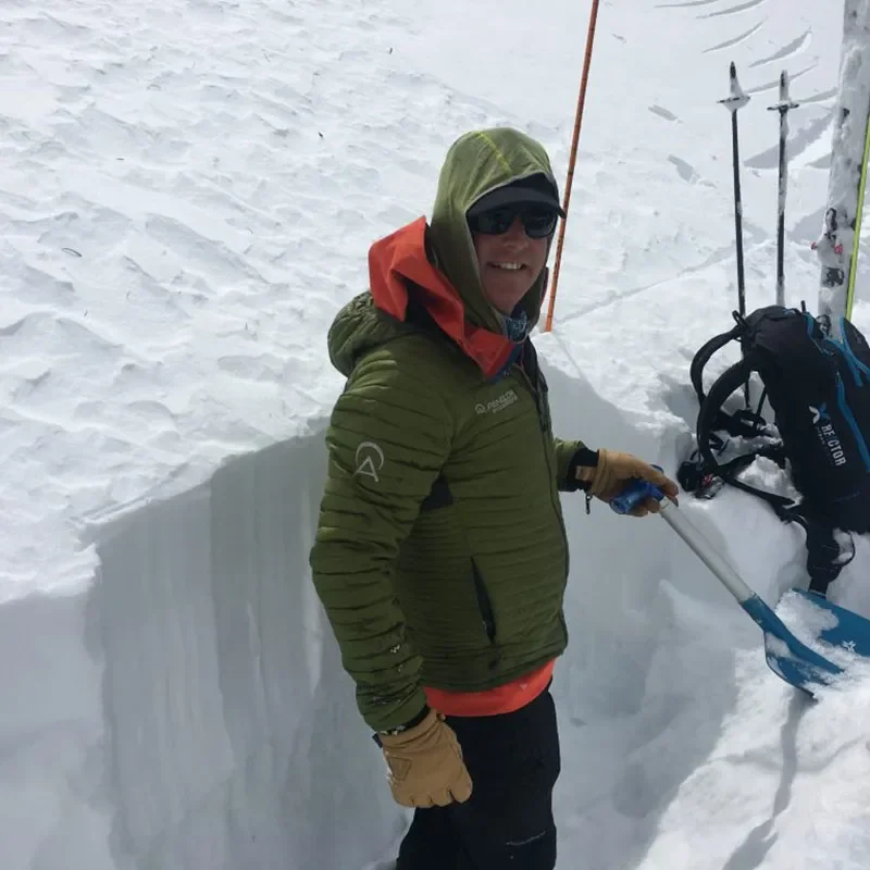 Avalanche Educator in Snow pit with shovel