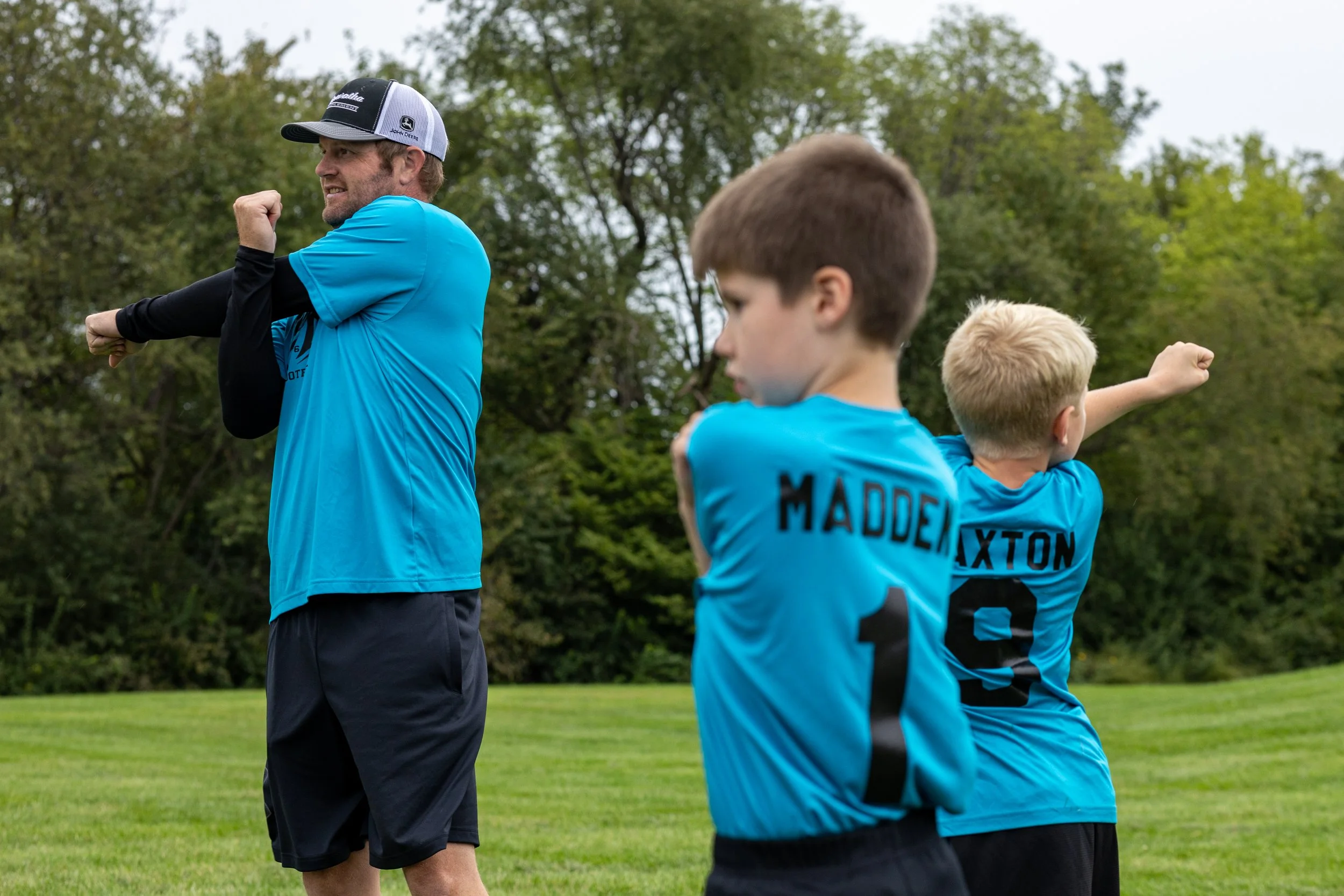 Russel leads his son Madden’s flag football team in some pregame stretches before their match in Maryville. Miller has coached his son’s team for four years and enjoys teaching the boys leadership and how to work together as team.