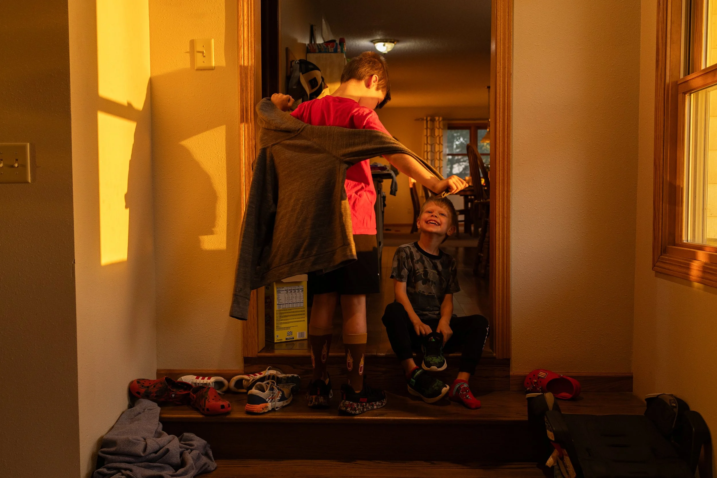 Russel’s sons Madden, 8, right, and Cutler Miller, 5, get ready to head off to school from their farmhouse home in Graham, Mo. Russel was raised in this same house by his parents Steve and Rita Miller, both 66, making it home to three generations of 