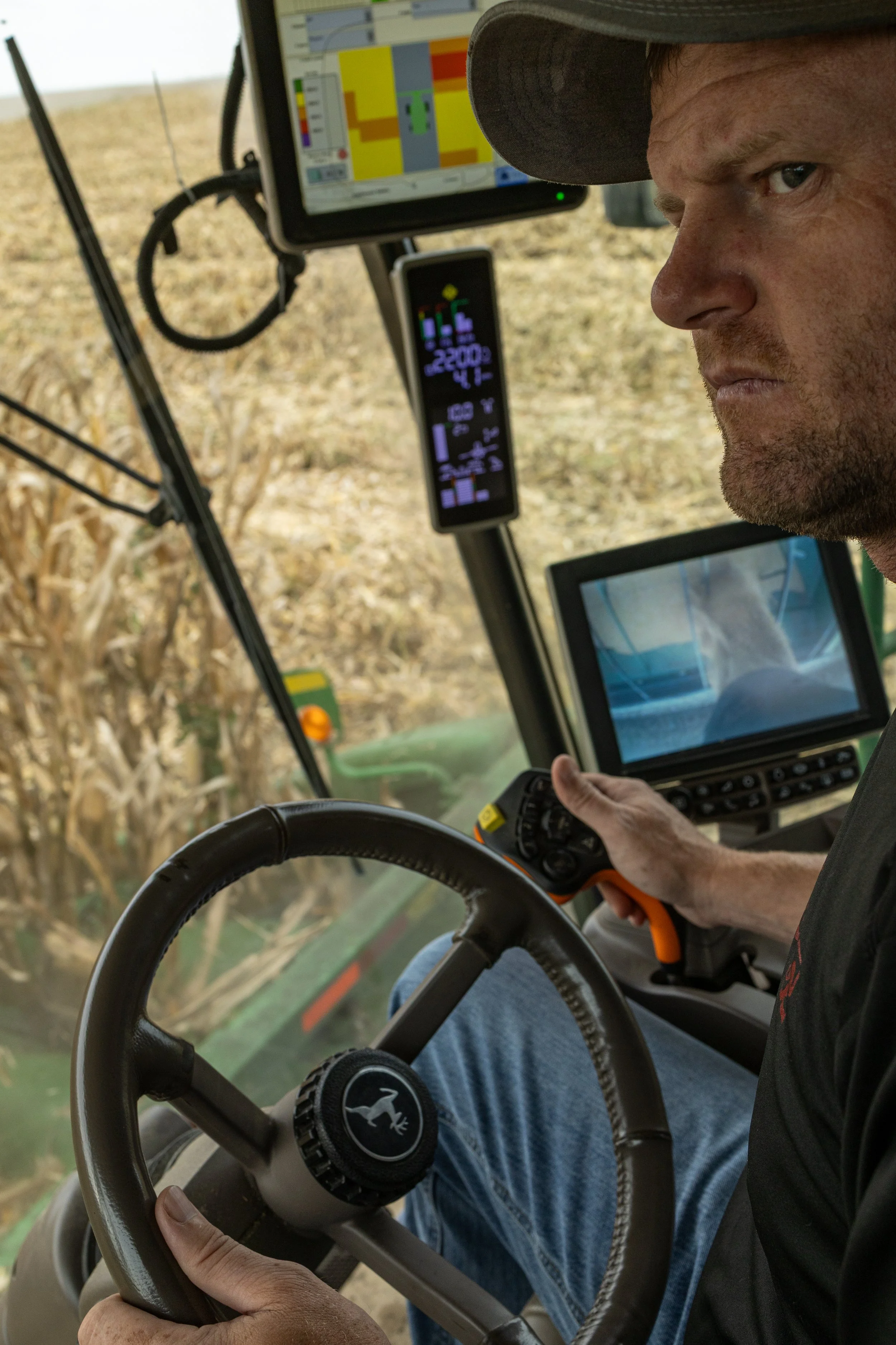 Russel Miller, 39, runs the combine through his crop while unloading on the go at his farm just outside of Maryville, Mo., on Sept. 24, 2026. “If a plane was going doing down, I think if you gave me enough time, I could probably get the plane landed 