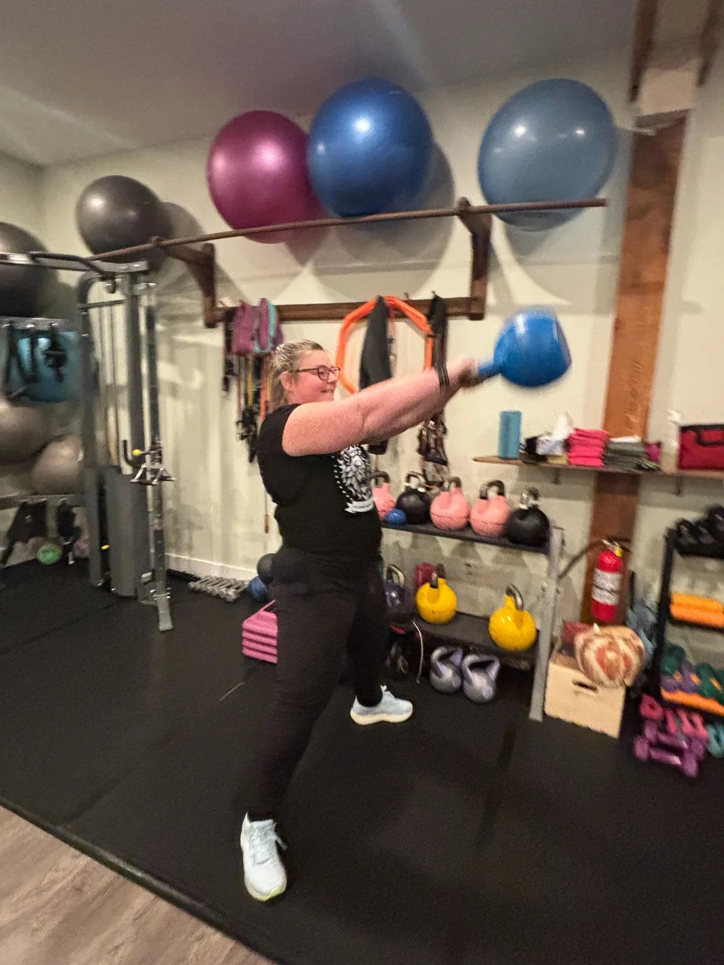 Laura in gym swinging kettle bell