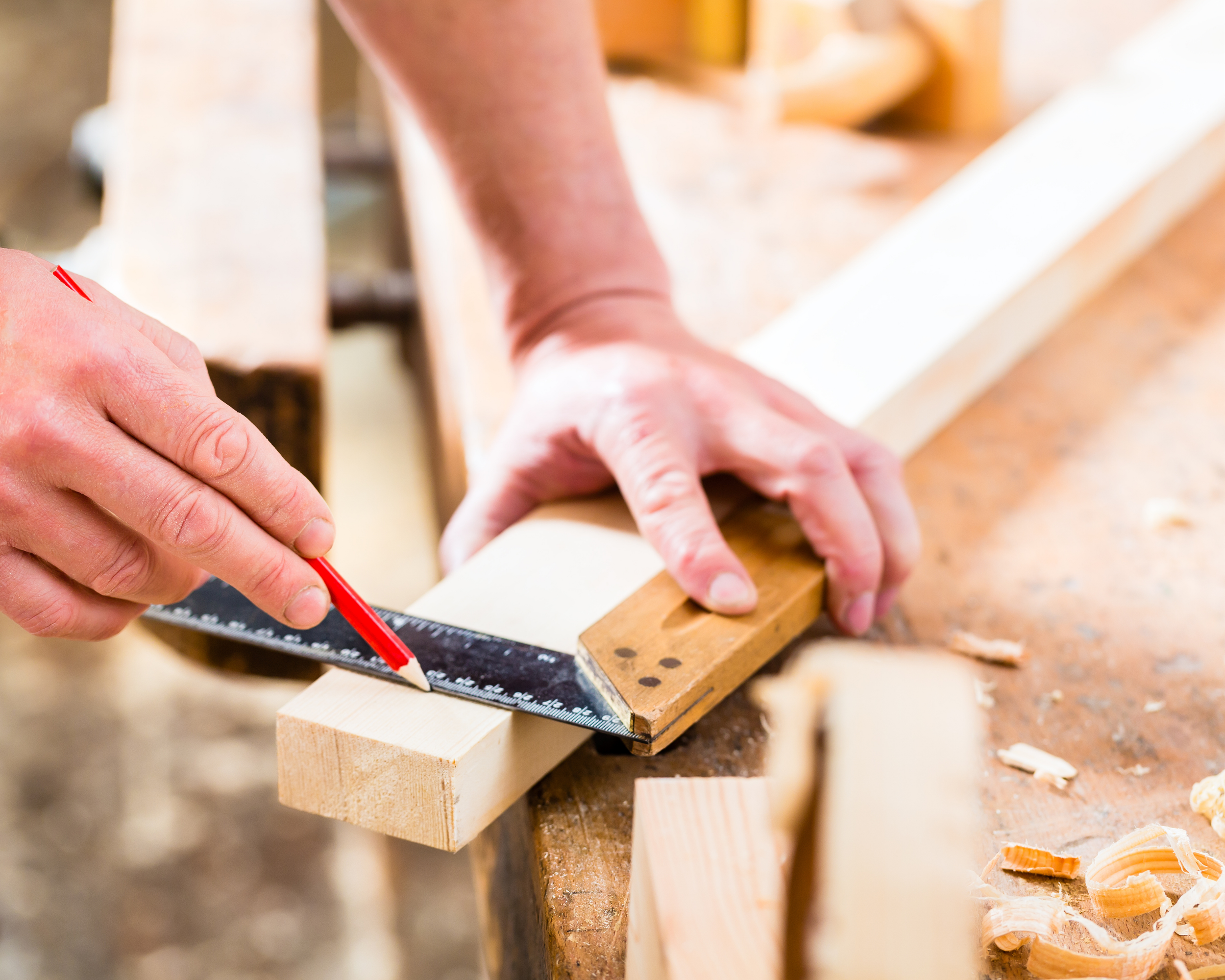 Carpenter marking a piece of wood