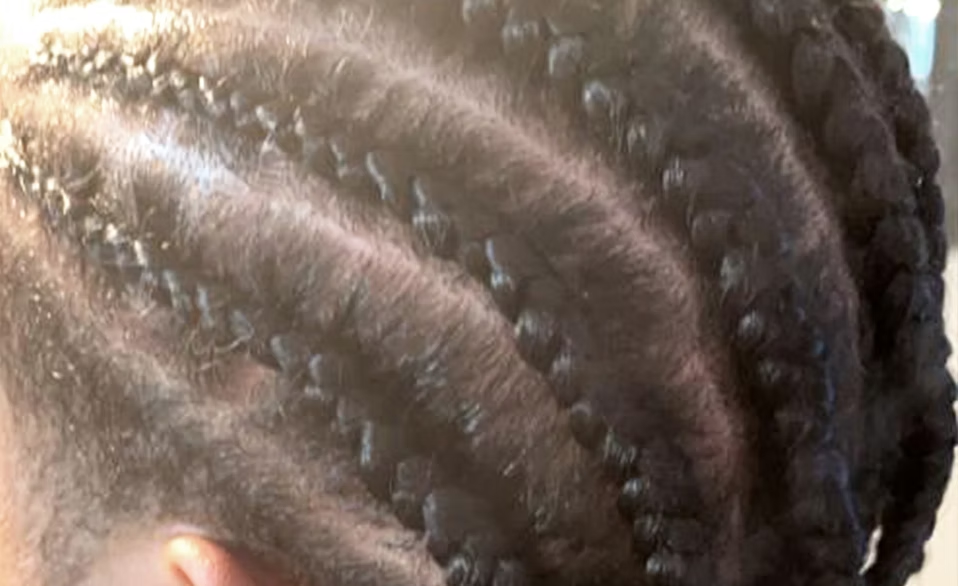 Close-up of neatly braided hair with small, tight cornrows.