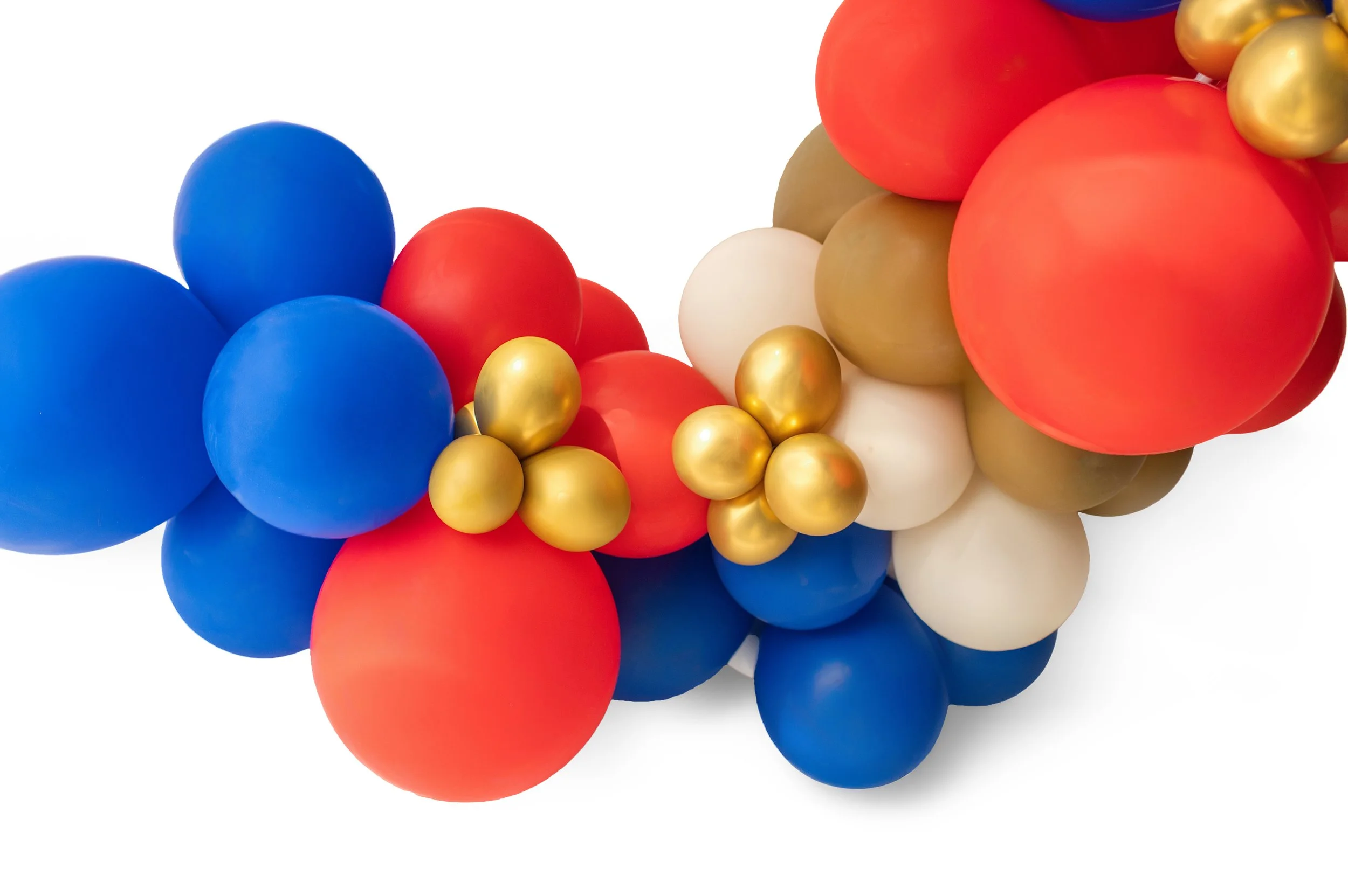Colorful balloons in blue, red, gold, white, and beige, clustered together on a white background.